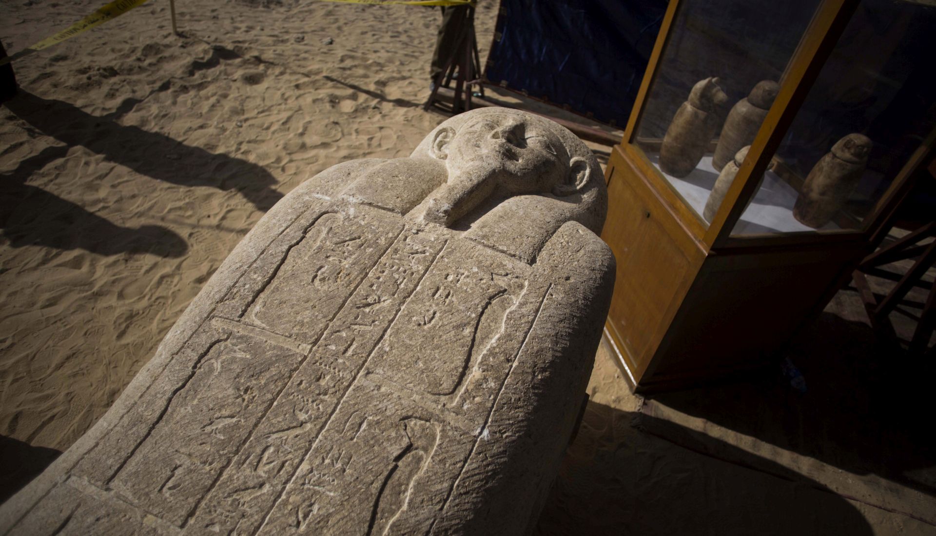 epa06560941 A sarcophagus that was discovered is displayed at the site of an ancient Egyptian cemetery, in Minya province, 245 km south of Cairo, Egypt, 24 February 2018. According to the Ministry of Antiquities, an ancient Egyptian cemetery was discovered six kilometers north of Tuna al-Gabal archaeological site in Minya, containing a number of burial shafts dating to the late pharaonic period and early Ptolemaic era. The archaeological mission unearthed a mummy decorated with a bronze collar, 1000 figurines, some 40 sarcophagi, four canopic jars, and other funerary items.  EPA/IBRAHIM YOUSSEF