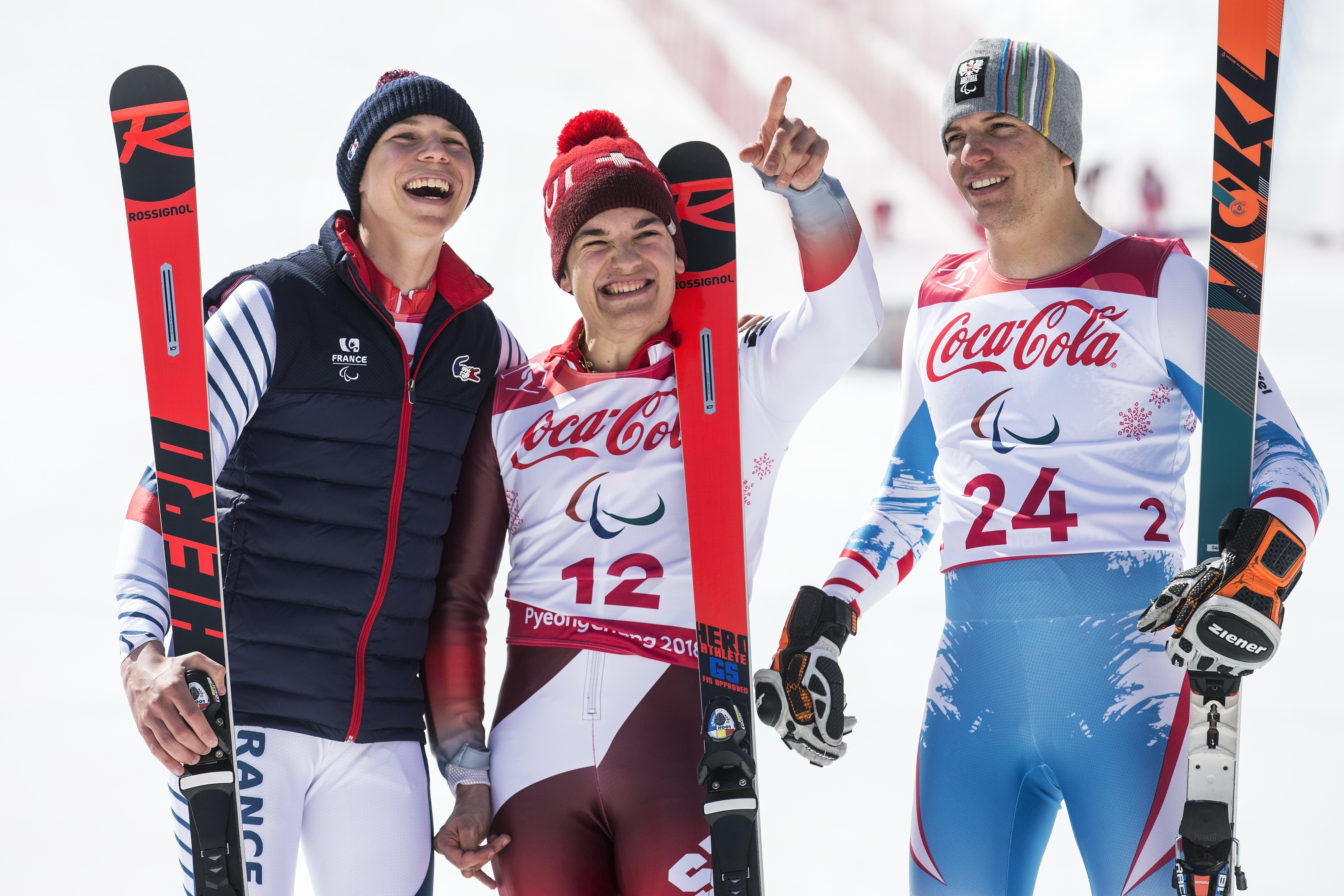 epa06592841 Silver medalist Arthur Bauchet of France, Gold medalist Theo Gmuer of Switzerland, and Bronze medalist Markus Salcher of Austria, from left, celebrate on the podium after the men Alpine Skiing downhill Standing race in the Jeongseon Alpine Center during the Winter Paralympics 2018 in Pyeongchang, South Korea, 10 March 2018.  EPA/ALEXANDRA WEY