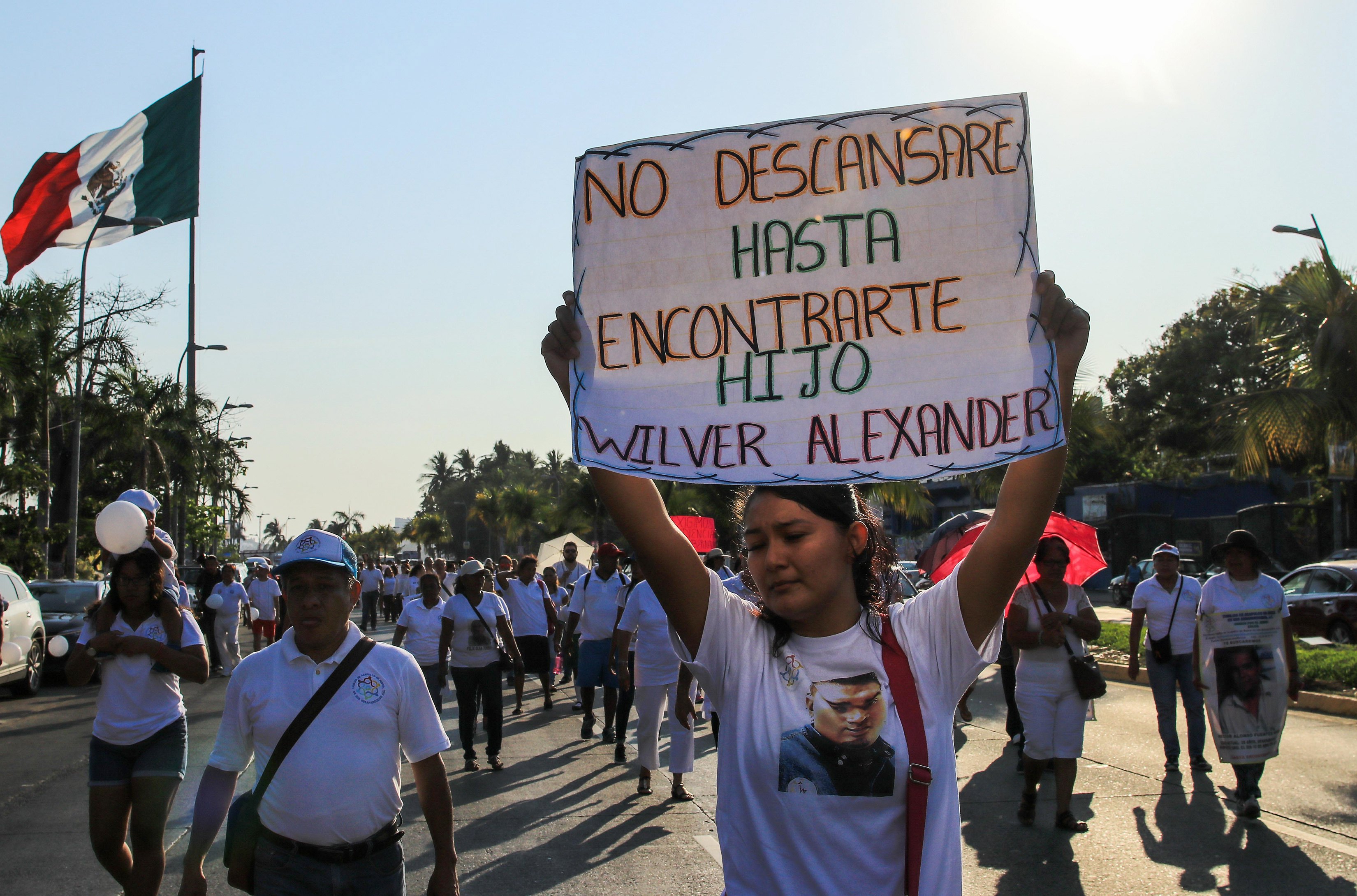 epa06602095 Members of the Third International Caravan of Search for the Disappeared protest through the main streets of the port of Acapulco, Guerrero, Mexico, 13 March 2018. Relatives of the 43 disappeared students of the Ayotzinapa teachers' school protested that the recent arrest of Erick Uriel Sandoval, known as 'the Frog', allegedly linked to the disappearance of the youth, is irrelevant.  EPA/DAVID GUZMAN