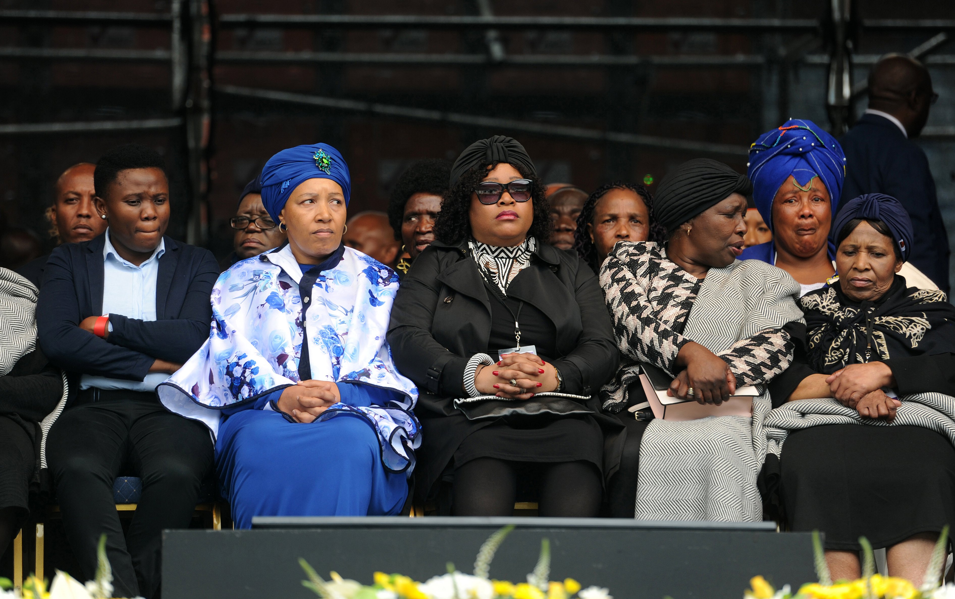 epa06660952 Winnie Madikizela-Mandela's daughters Zanani (2-L) and Zindzi (3-L) with family members attend the memorial service of Winnie Madikizela-Mandela at the Orlando stadium in Soweto, South Africa, 11 April 2018. Winnie Mandela, former wife of Nelson Madela and anti-apartheid activist, passed away in a Johannesburg hospital on 02 April 2018 at age 81. South African President Cyril Ramaphosa declared 10 days of national mourning for the late Winnie Madikizela-Mandela and ordered an official memorial and state funeral in her honor which will take place 11 and 14 April.  EPA/STR