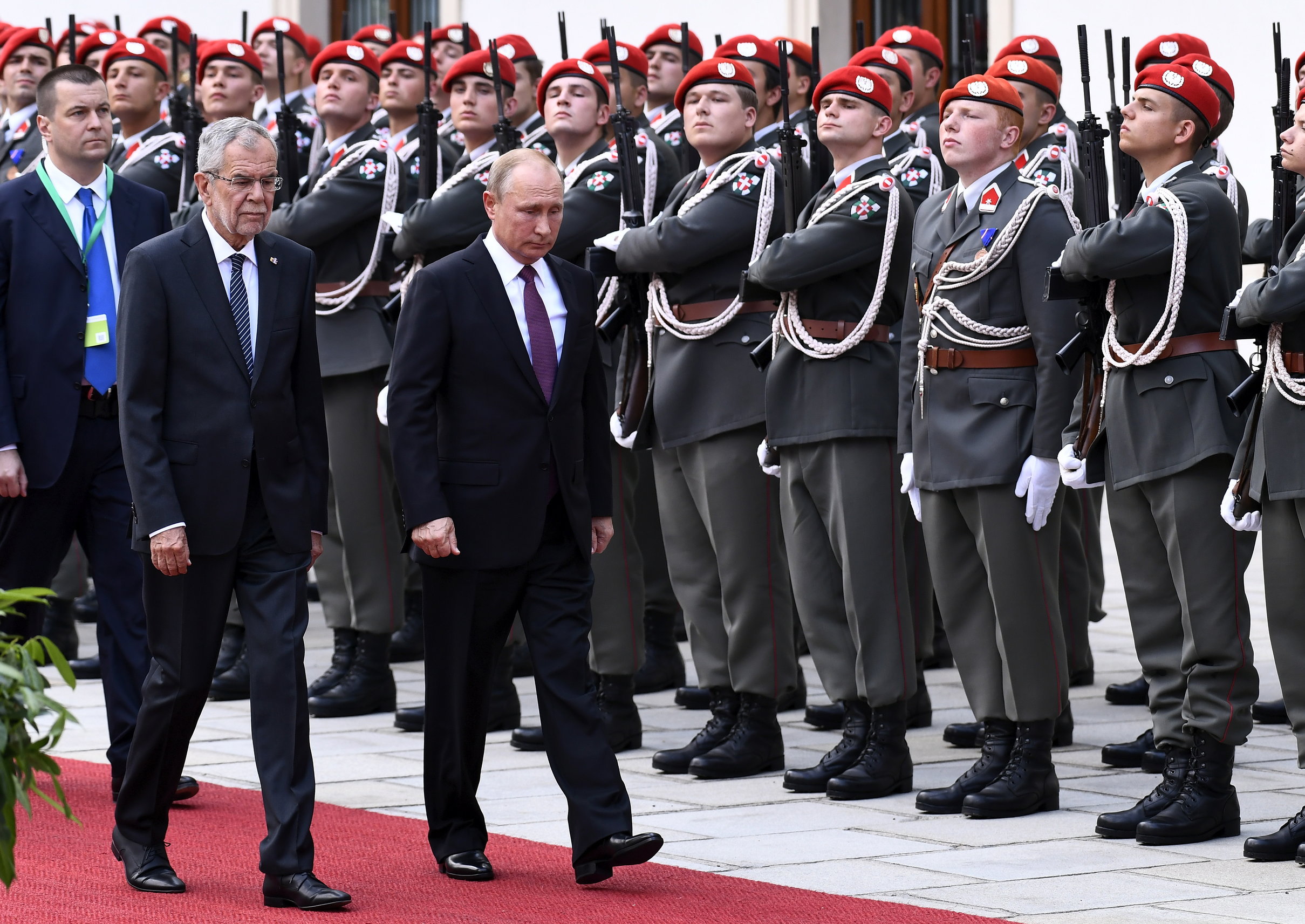 epa06786368 Russian President Vladimir Putin (R) and Austrian Federal President Alexander Van der Bellen (L) pass the Guard of Honor, prior to their meeting at the presidential office of the Hofburg Palace in Vienna, Austria, 05 June 2018. Putin is in Austria for a one-day official state visit.  EPA/CHRISTIAN BRUNA