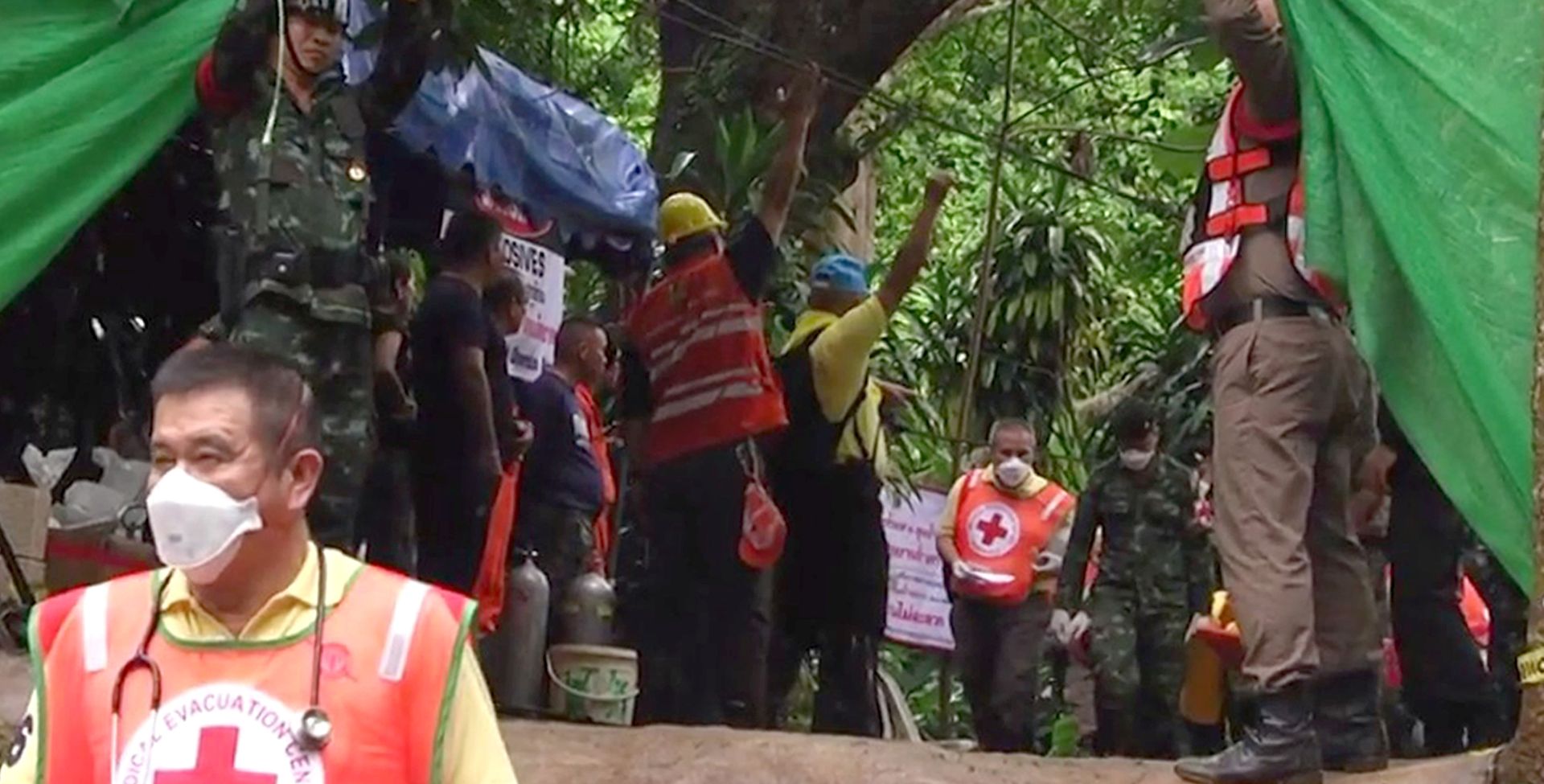 epa06874594 A handout photo made available by the Chiang Rai Public Relations Office on 09 July 2018 shows emergency workers carrying one of the boys from a youth soccer team to transport him to a hospital at Tham Luang cave in Khun Nam Nang Non Forest Park, Chiang Rai province, Thailand, 08 July 2018. According to reports, four boys have been rescued and evacuated to a hospital on 08 July 2018, as rescue operations continue for the 13 members of a youth soccer team including their assistant coach who have been trapped in Tham Luang cave since 23 June 2018. Operations are underway to safely bring out the rest of them after the oxygen tanks are refilled.  EPA/CHIANG RAI PR OFFICE HANDOUT BEST QUALITY AVAILABLE HANDOUT EDITORIAL USE ONLY/NO SALES
