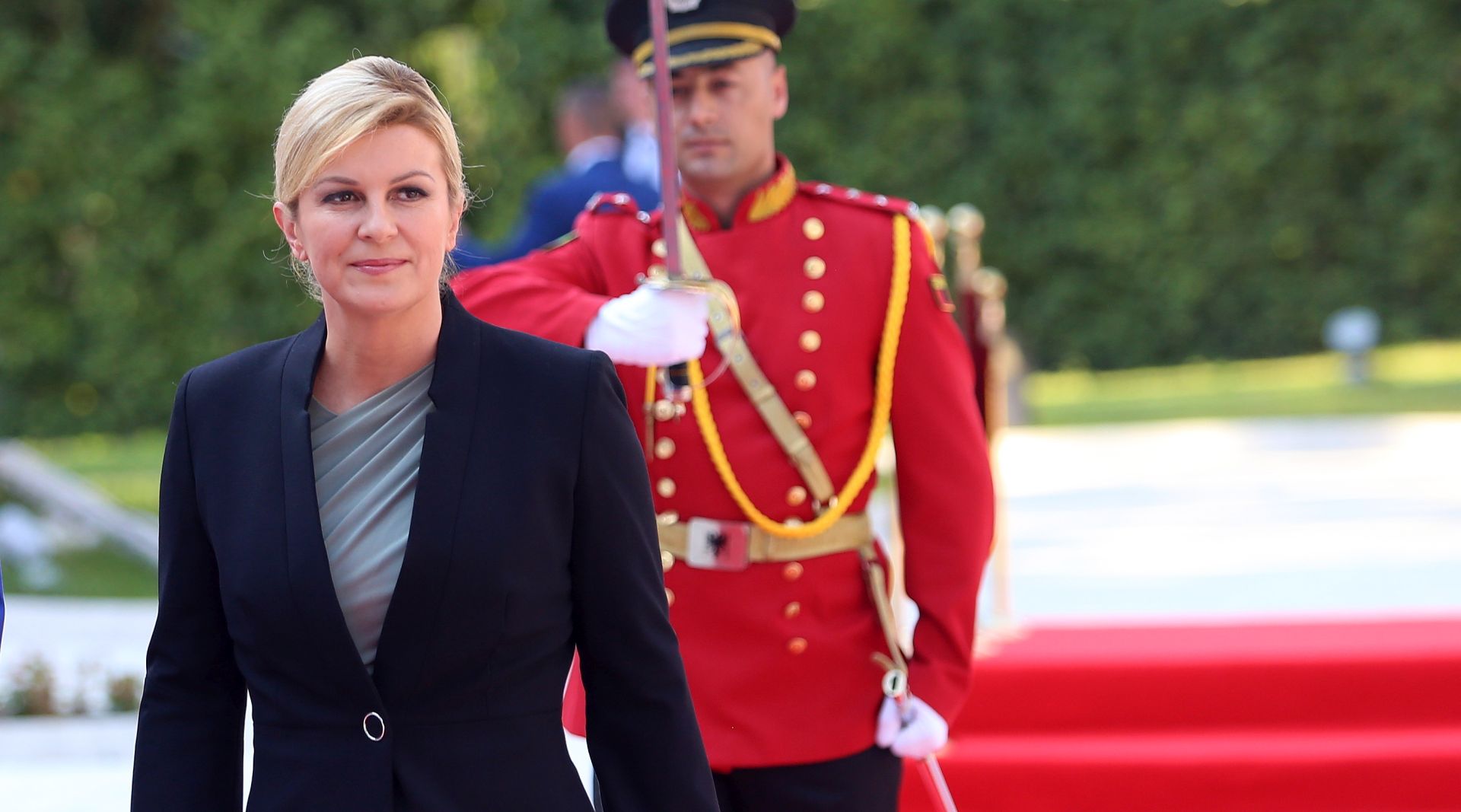 epa06896985 President of Republic of Croatia Kolinda Grabar-Kitarovic after a welcoming ceremony with her Albanian counterpart Ilir Meta (not in picture) in Tirana, Albania, on 18 July 2018. Kolinda Grabar-Kitarovic arrived in Albania for a three-day official visit.  EPA/MALTON DIBRA