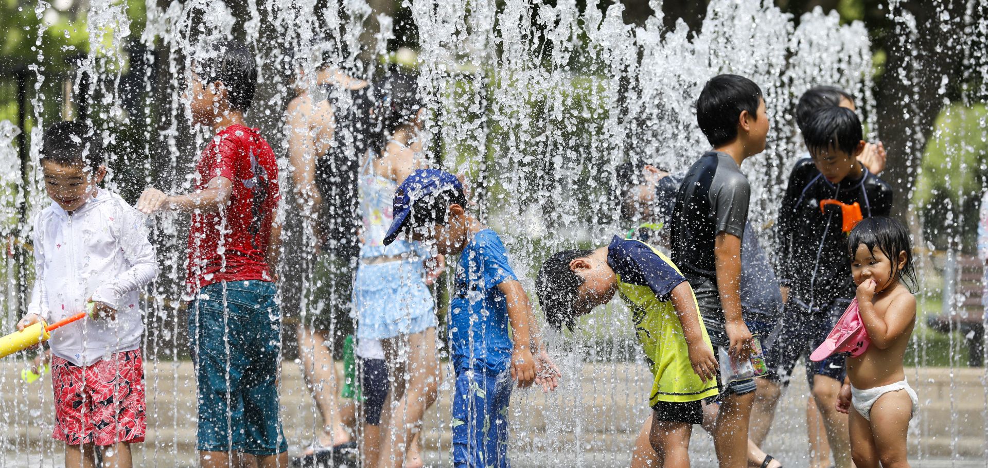 epa06905869 Children play in the water jets at a park near Nerima in Tokyo, Japan, 23 July 2018 as temperature rose up to 39.6 degrees Celsius, the highest temperature since the start of weather information record. While central Tokyo hit the 39 degrees mark, the city of Kumagaya, north of Tokyo measured 41.1 degrees Celsius , the yet highest temperature in Japan. From the end of April to mid-July 2018, reportedly so far 21,166 people were taken to hospital for heat related problems, alone from 09 to 15 July, a total of 9,956 people were hospitalized due to suffering from the hot weather conditions, Japan's Fire and Disaster Management Agency said.  EPA/KIMIMASA MAYAMA