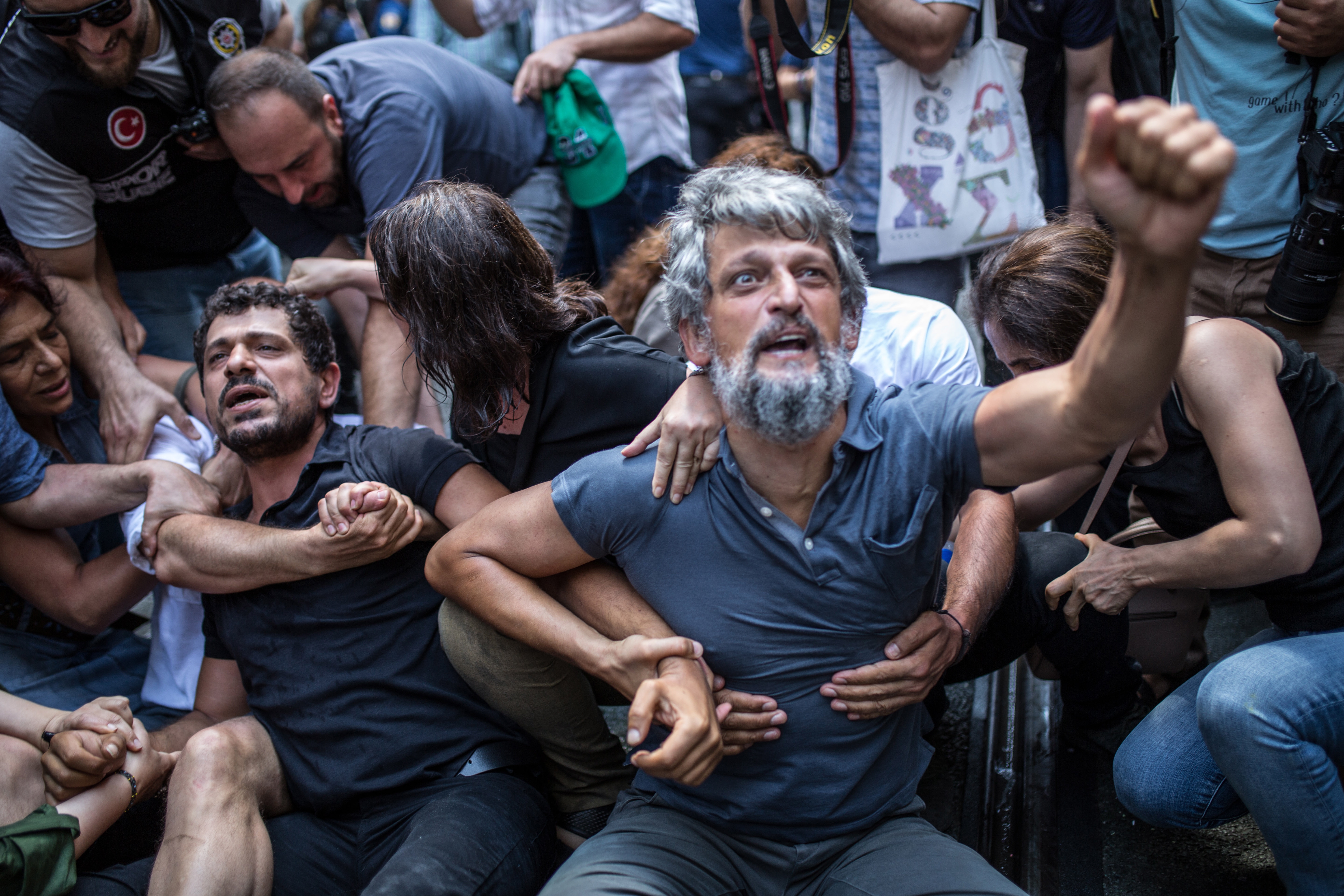 epa06971967 Pro-Kurdish Peoples Democratic Party (HDP) lawmakers Garo Paylan (C) reacts to polices during a Saturday Mothers 700th gathering at Istiklal street in Istanbul, Turkey, 25 August 2018. Mothers are while sits every saturday at Istiklal Street for wives and relatives holding pictures of their relatives and demand clarification for the disappearence of their relatives, who are belived to be arrested, torturted or killed.  EPA/STR