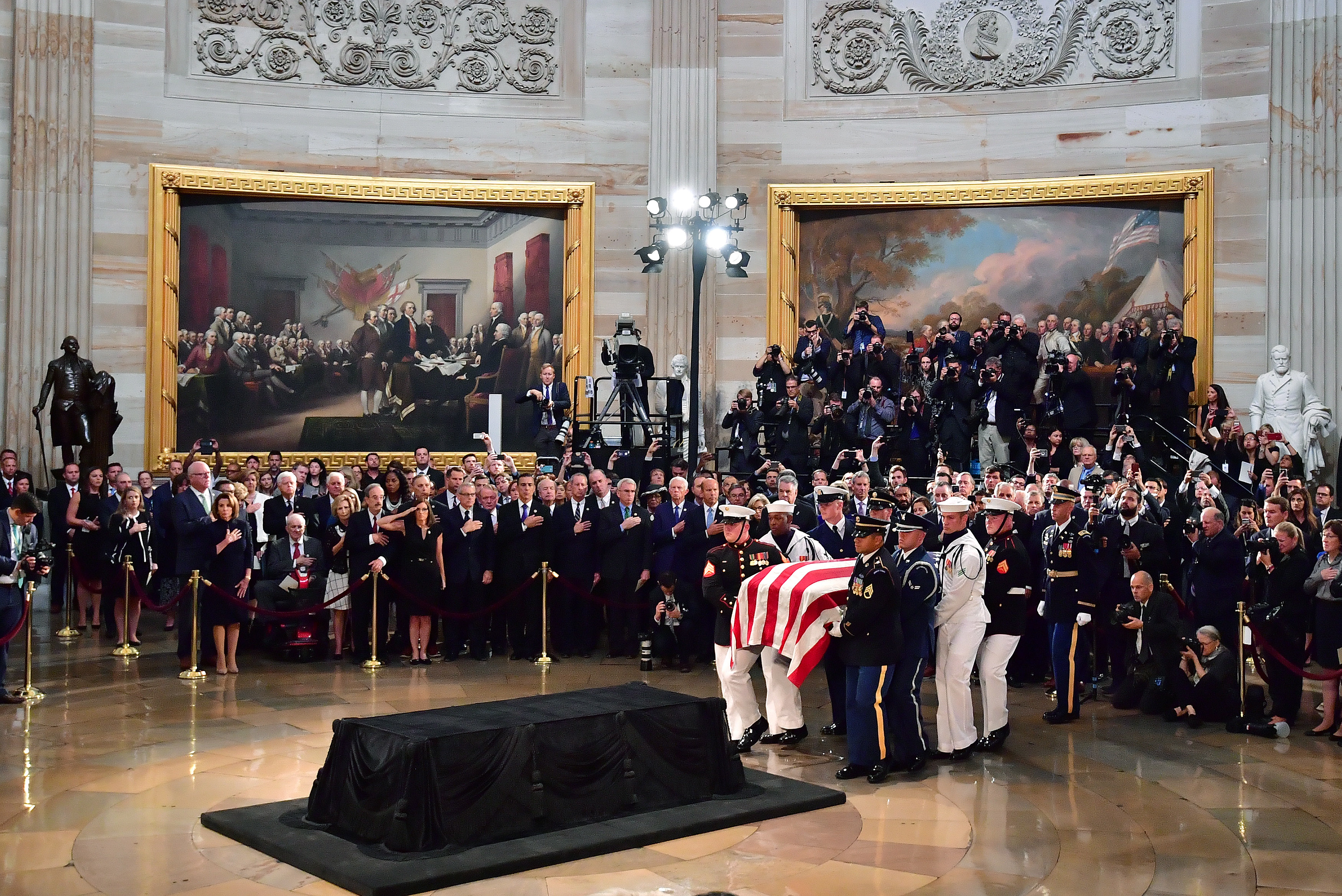 epa06987685 A military honor guard carries the casket of former Senator John McCain into the Capitol Rotunda where he will lie in state at the U.S. Capitol, in Washington, DC, USA, 31 August 2018. McCain will lie in state at the US Capitol and have a funeral service at the National Cathedral before being laid to rest at the US Naval Academy in Annapolis, Maryland. McCain died 25 August, 2018 from brain cancer at his ranch in Sedona, Arizona, USA. He was a veteran of the Vietnam War, served two terms in the US House of Representatives, and was elected to five terms in the US Senate. McCain also ran for president twice, and was the Republican nominee in 2008.  EPA/KEN CEDENO / POOL