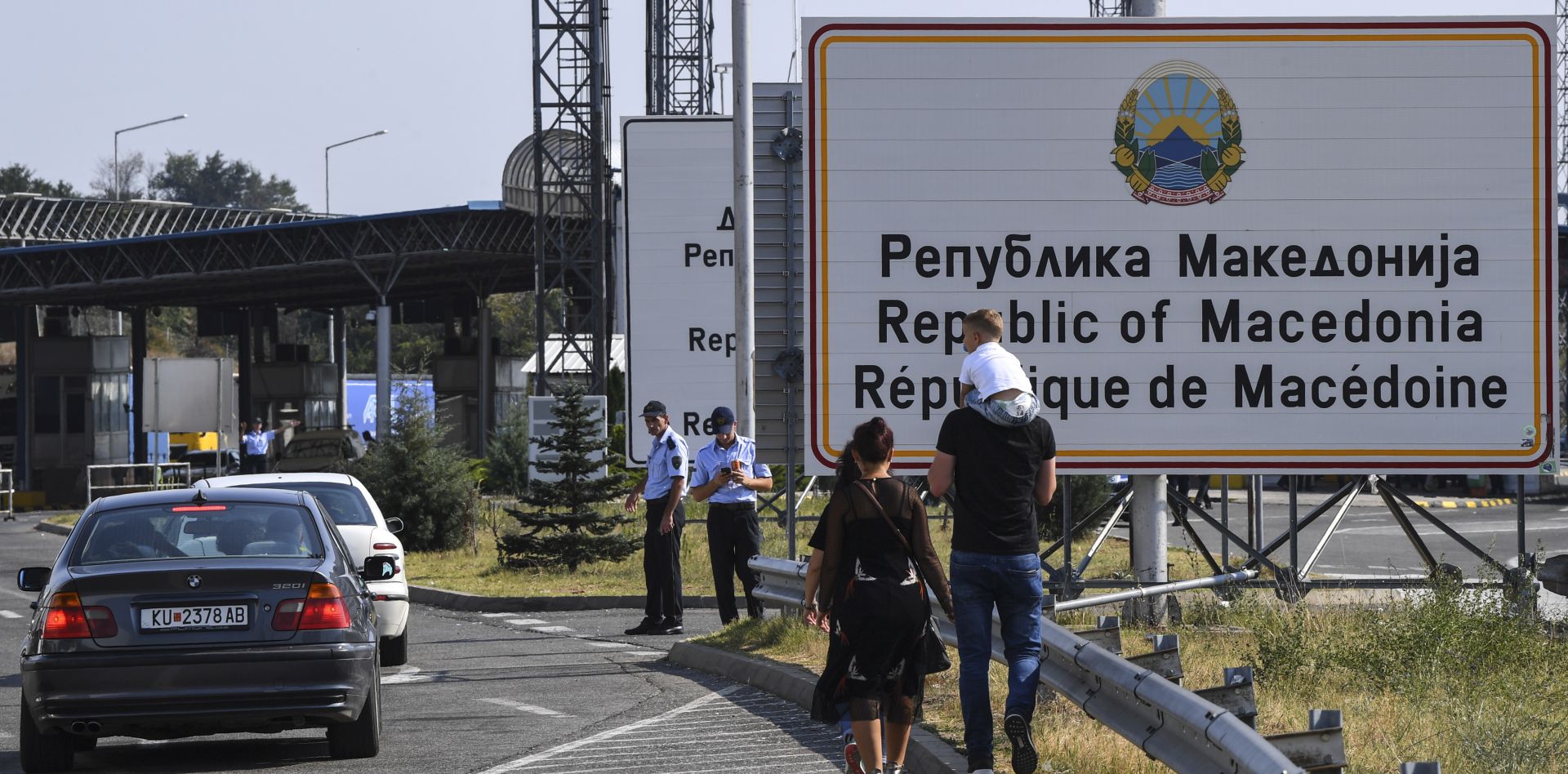 epa06992835 People walk near the Republic of Macedonia sign at the border crossing Tabanovce between The Former Yugoslav Republic of Macedonia and Serbia, 02 September 2018. Serbian President Aleksandar Vucic and The Former Yugoslav Republic of Macedonia, Prime Minister Zoran Zaev are meeting to discuss the project of integrated border control called 'One stop shop'.  EPA/GEORGI LICOVSKI