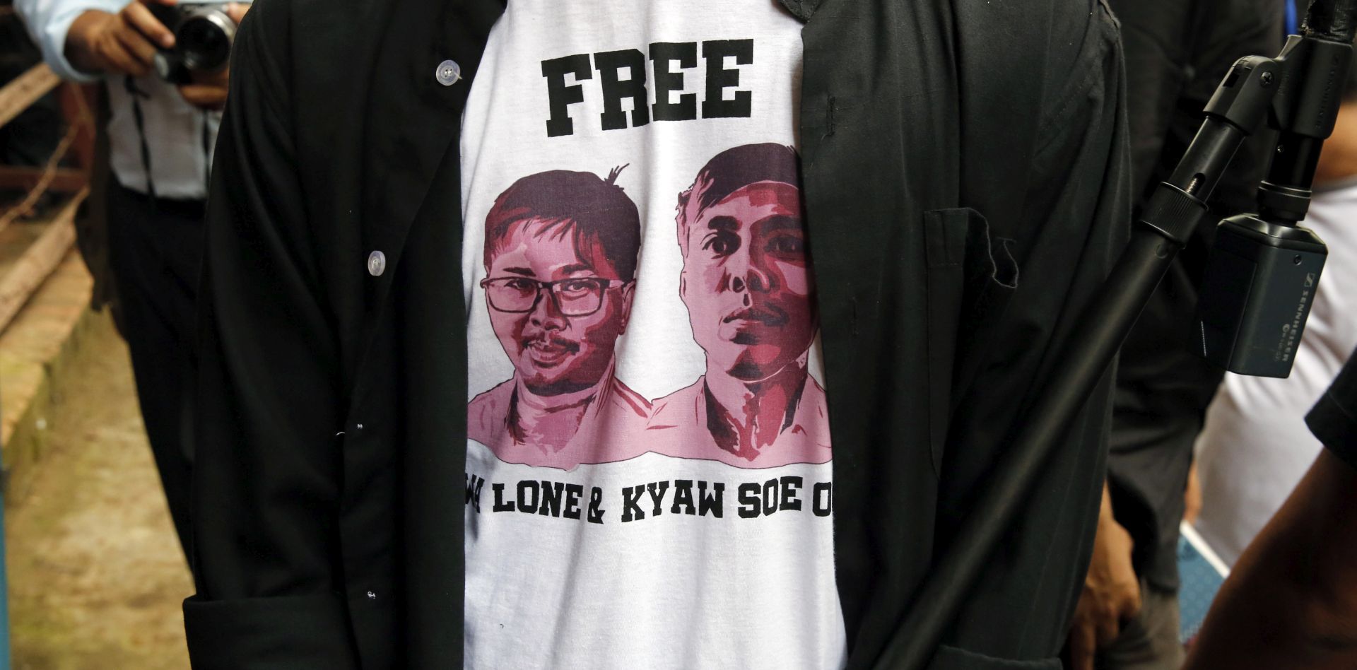 epa06993695 A journalists wearing a shirt with the image of Reuters journalists Wa Lone and Kyaw Soe Oo stands outside Insein township court to hear the journalist's verdict in Yangon, Myanmar, 03 September 2018. The Myanmar court on 27 August 2018 postponed the verdict in the trial of Reuters journalist Wa Lone and Kyaw Soe Oo to 03 September 2018. Reuters journalists Wa Lone and Kyaw Soe Oo were arrested in the outskirts of Yangon on 12 December 2017 by Myanmar police for allegedly possessing classified police documents. Both defendants say they were framed by police.  EPA/LYNN BO BO