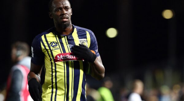 Olympic sprinter Usain Bolt gestures as he plays for A-League football club Central Coast Mariners in a pre-season practice match against a Central Coast amateur selection team in Gosford, New South Wales on August 31, 2018. Sprint king Usain Bolt made his much-anticipated football debut on August 31, exciting fans but tiring quickly in a 20-minute cameo as his Central Coast Mariners hammered an amateur side 6-1 in a pre-season warm-up.,Image: 384786334, License: Rights-managed, Restrictions: -- IMAGE RESTRICTED TO EDITORIAL USE - STRICTLY NO COMMERCIAL USE --, Model Release: no, Credit line: Andrew Murray / AFP / Profimedia