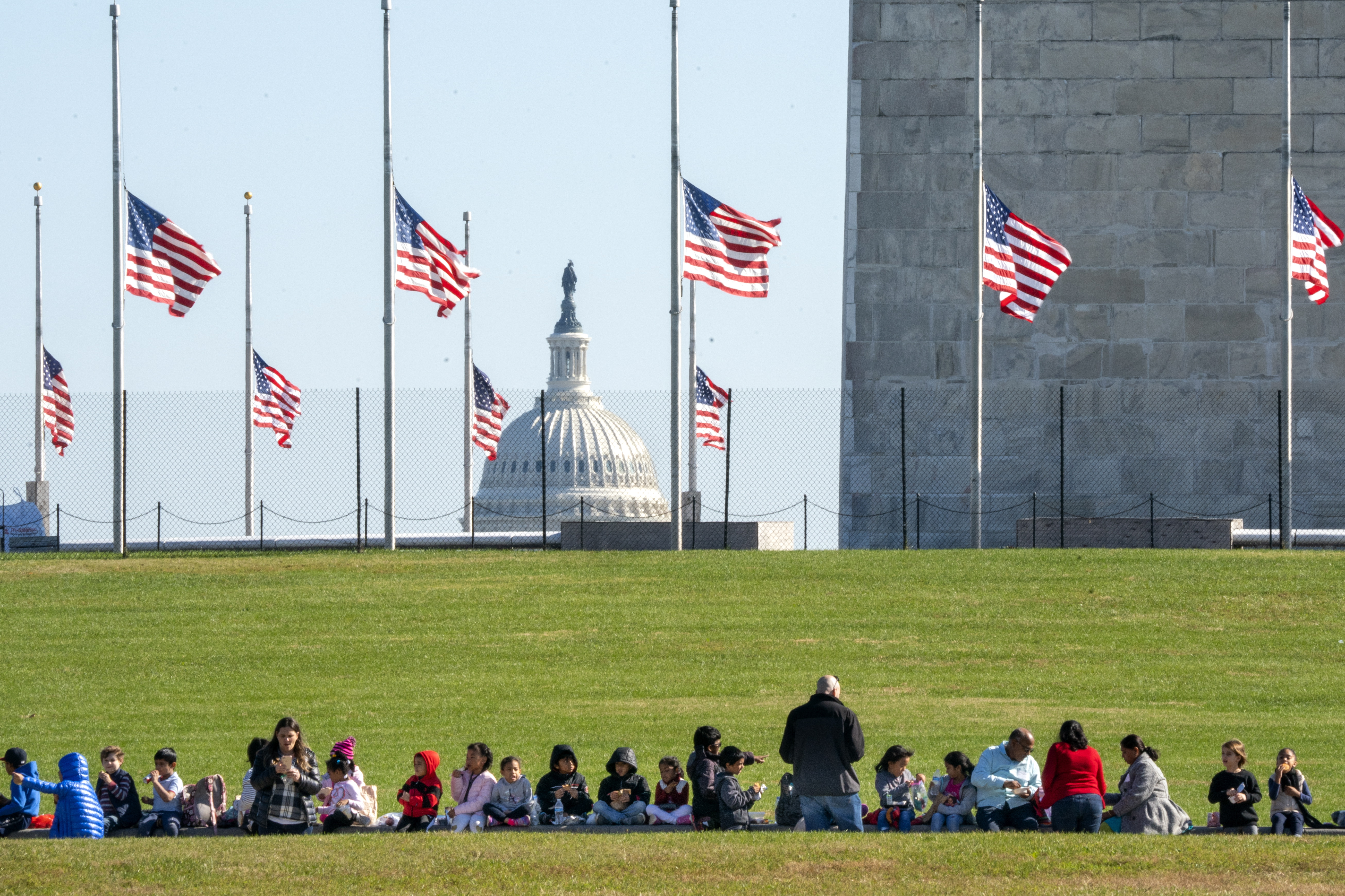 epa07131695 Flags on the National Mall fly at half-staff to honor the victims of the mass shooting at the Tree of Life Synagogue in Pittsburgh, Pennsylvania, in Washington, DC, USA, 30 October 2018. President Trump is expected to visit the site of the mass shooting later on 30 October, a move that has drawn mixed reaction in the Pittsburgh community.  EPA/JIM LO SCALZO