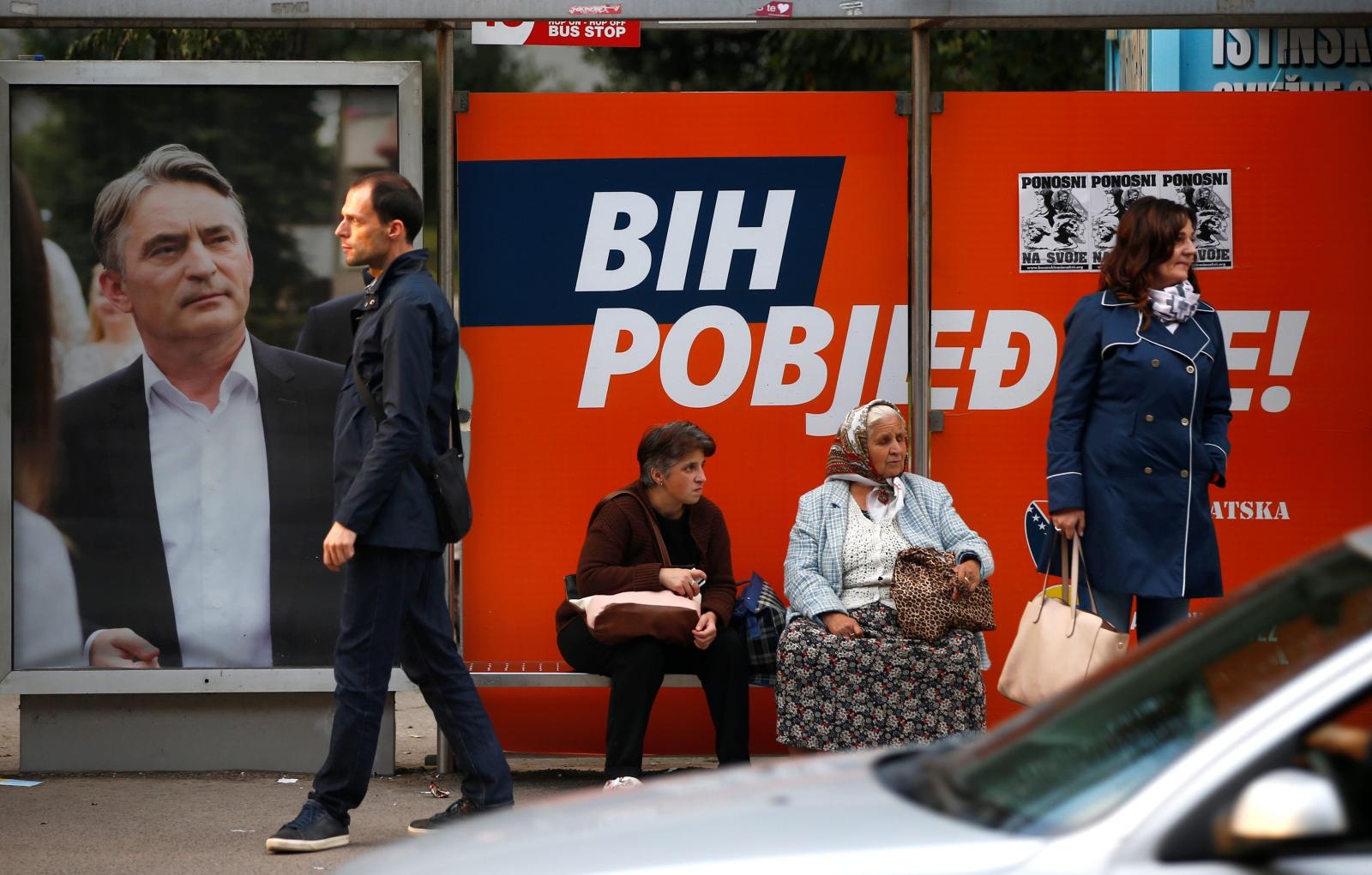 People wait for a bus next to Zeljko Komsic pre-election poster in Sarajevo People wait for a bus next to a Zeljko Komsic pre-election poster in Sarajevo, Bosnia and Herzegovina October 5, 2018. REUTERS/Dado Ruvic DADO RUVIC