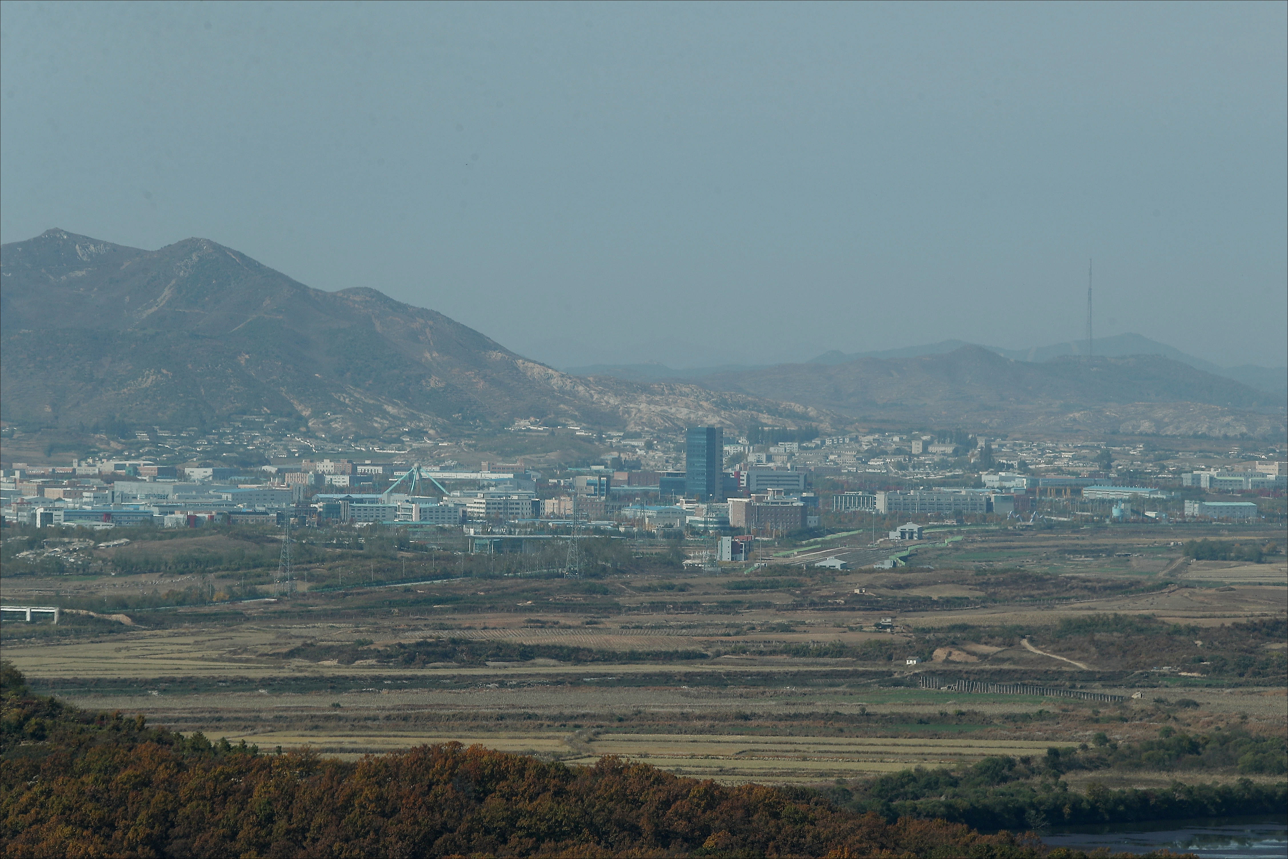 epa07118116 A view of the Kaesong Industrial Complex, an inter-Korean factory park in the North Korean border city of Kaesong, as visible from a South Korean observatory in Paju, South Korea, 25 October 2018, during a visit to the observatory by members of the parliamentary land and transportation committee. South Korea's presidential office said Seoul has no plans to reopen the complex, shuttered in early 2016 in response to the North's nuclear and missile tests, unless international sanctions are lifted first.  EPA/YONHAP / POOL SOUTH KOREA OUT