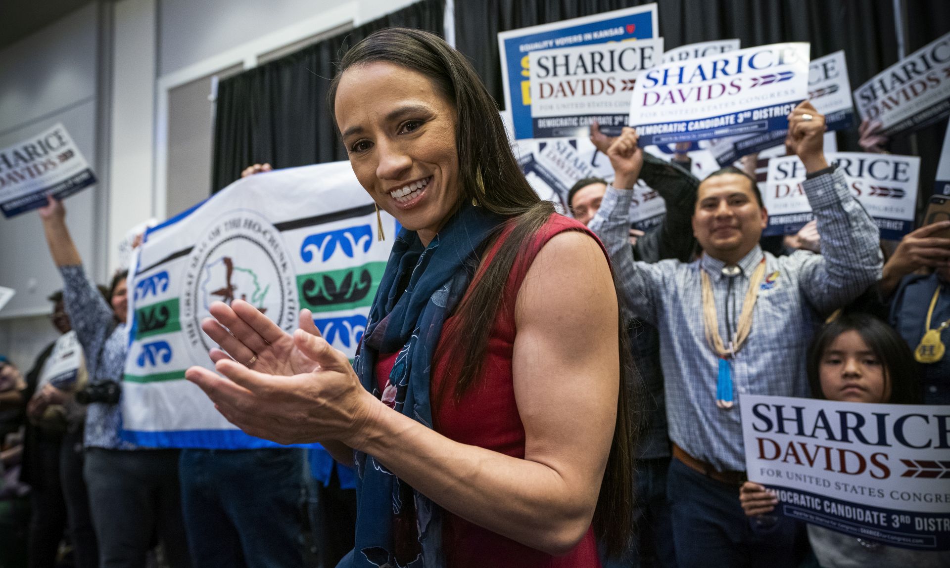 epa07147358 Democratic House candidate from Kansas Sharice Davids celebrates after winning her race at her election night watch party at the Embassy Suites Hotel in Olathe, Kansas, USA, 06 November 2018. Davids is the first lesbian Native American Congresswoman by beating Republican incumbent Kevin Yoder. Davids is one of several first-time female candidates that helped the Democratic Party takeover in the House of Representatives.  EPA/JIM LO SCALZO