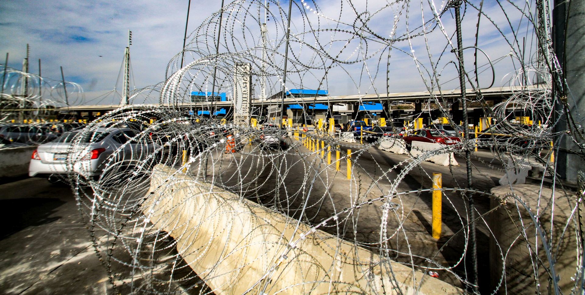epa07178058 A view of a wire fence at the San Ysidro border checkpoint which connects San Diego and Tijuana, in Mexico, 19 November 2018. Thousands of migrants wait to demand asylum in the US as the border access has been closed for some hours in order to place 'reinforcement materials', which interrupted the crossing of vehicles and people temporarily.  EPA/Joebeth Terriquez