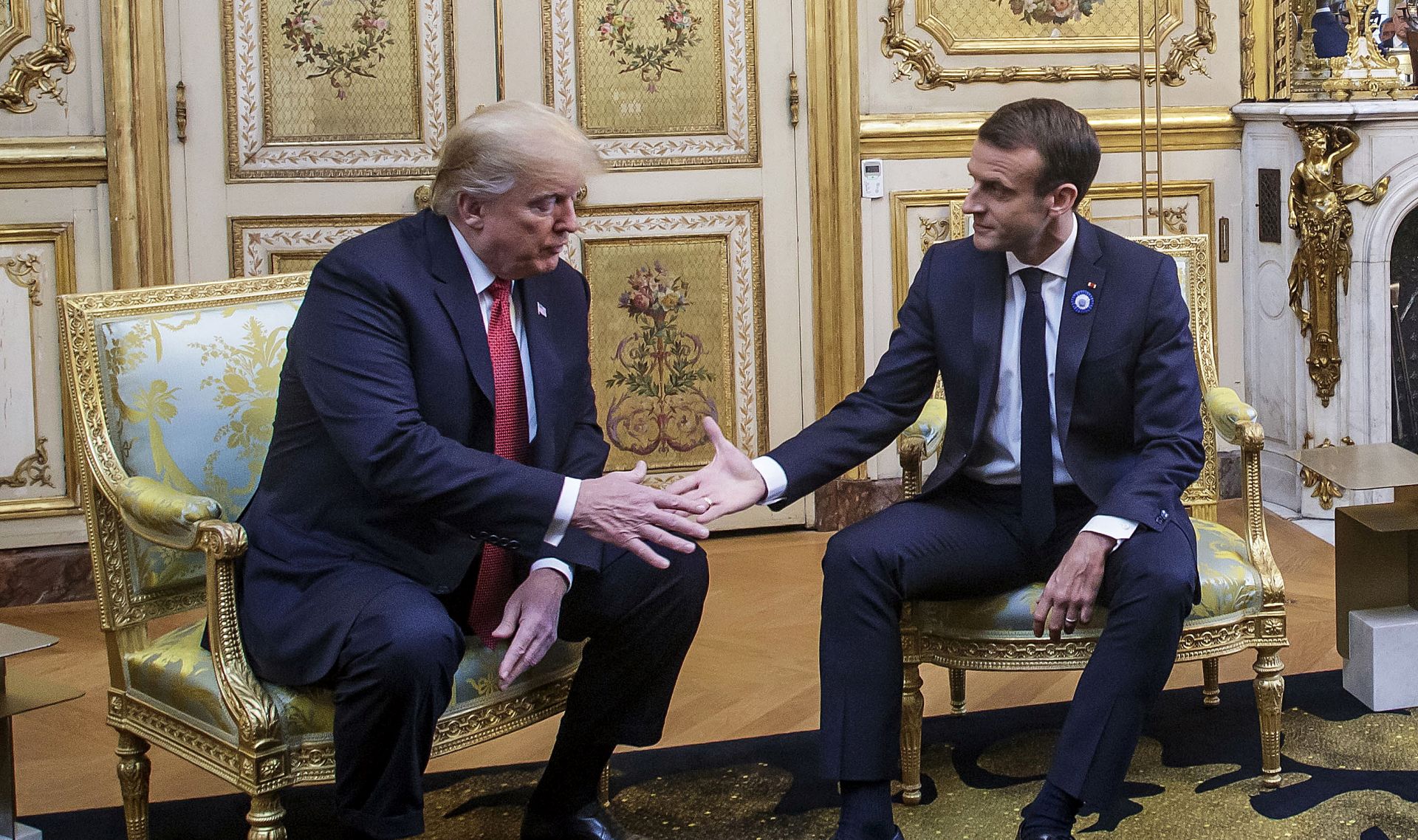 epa07154867 French President Emmanuel Macron (R) and US President Donald J. Trump (L) shake hands during their meeting at the Elysee palace in Paris, France, 10 November 2018, ahead of the international ceremony for the Centenary of the WWI Armistice of 11 November 1918. US President Trump along with other Heads of States and Governments will join on 11 November the commemoration ceremonies for their countries' fallen WW1 soldiers in France.  EPA/CHRISTOPHE PETIT TESSON / POOL
