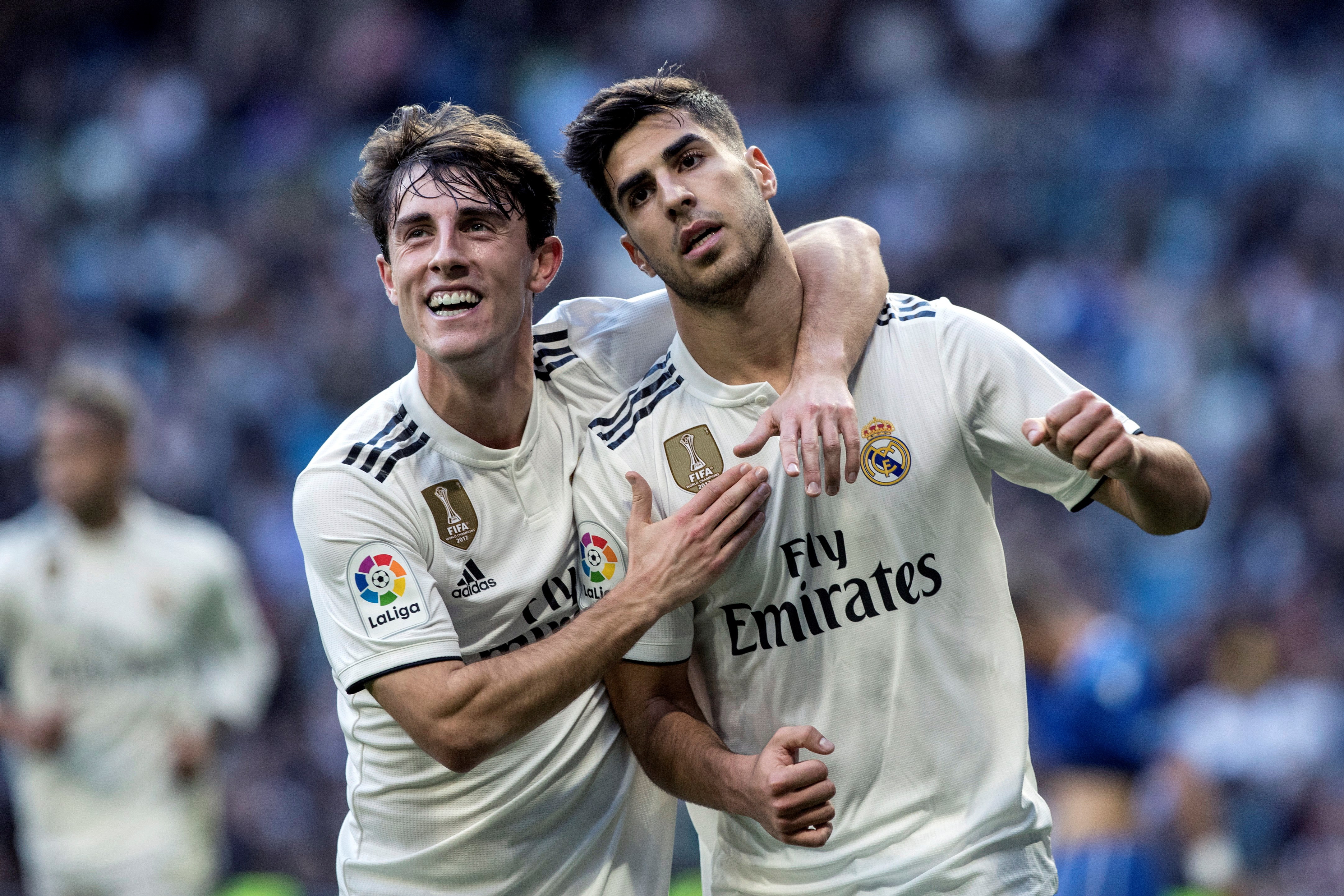 epa07212694 Real Madrid's midfielder Marco Asensio (R) celebrates with his teammate Alvaro Odriozola after scoring the 1-0 during a Spanish King's Cup round of 32 second leg match between Real Madrid and Melilla at the Santiago Bernabeu stadium, in Madrid, Spain, 06 December 2018.  EPA/Rodrigo Jimenez