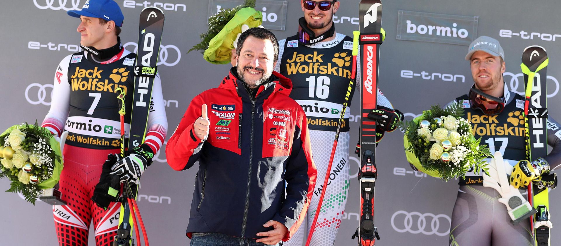 epa07252771 Italian Prime Minister Matteo Salvini (C) with second placed Matthias Mayer (L) of Austria, winner Dominik Paris (R) of Italy and third placed Aleksander Aamodt Kilde (2-R) of Norway celebrate on the podium after the Men's SuperG race at the FIS Alpine Skiing World Cup in Bormio, Italy, 29 December 2018.  EPA/ANDREA SOLERO