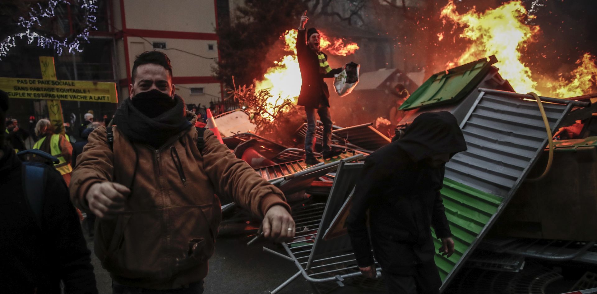 epa07264058 Protesters build a barricade half set on fire as clashes erupt between protesters and the French riot police during a 'Yellow Vests' protest in Paris, France, 05 January 2019. The so-called 'gilets jaunes' (yellow vests) is a grassroots protest movement with supporters from a wide span of the political spectrum, that originally started with protest across the nation in late 2018 against high fuel prices. The movement in the meantime also protests the French government's tax reforms, the increasing costs of living and some even call for the resignation of French President Emmanuel Macron.  EPA/IAN LANGSDON