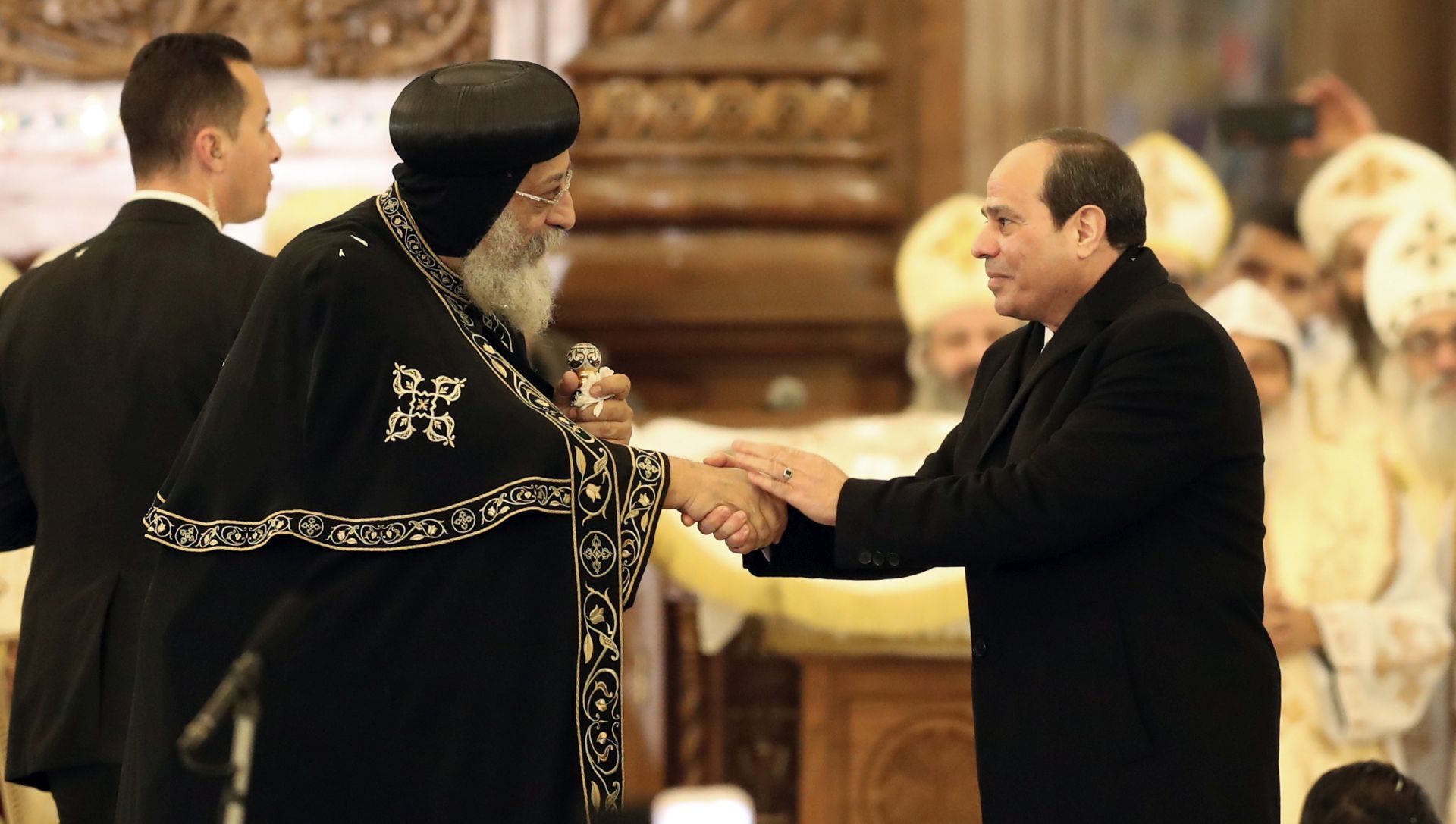 epa07266074 Pope Tawadros II of Alexandria (L) listens as Egyptian President Abdel Fattah al-Sisi (R) speaks before mass at the newly inaugurated Cathedral of Nativity in the New Administrative Capital, Egypt, 06 January 2019. The Middle East's biggest cathedral is inaugurated by Eygpt's President  a day after a deadly bomb blast near a church. Orthodox believers celebrate Christmas Day on 07 January, according to the Julian calendar.  EPA/KHALED ELFIQI