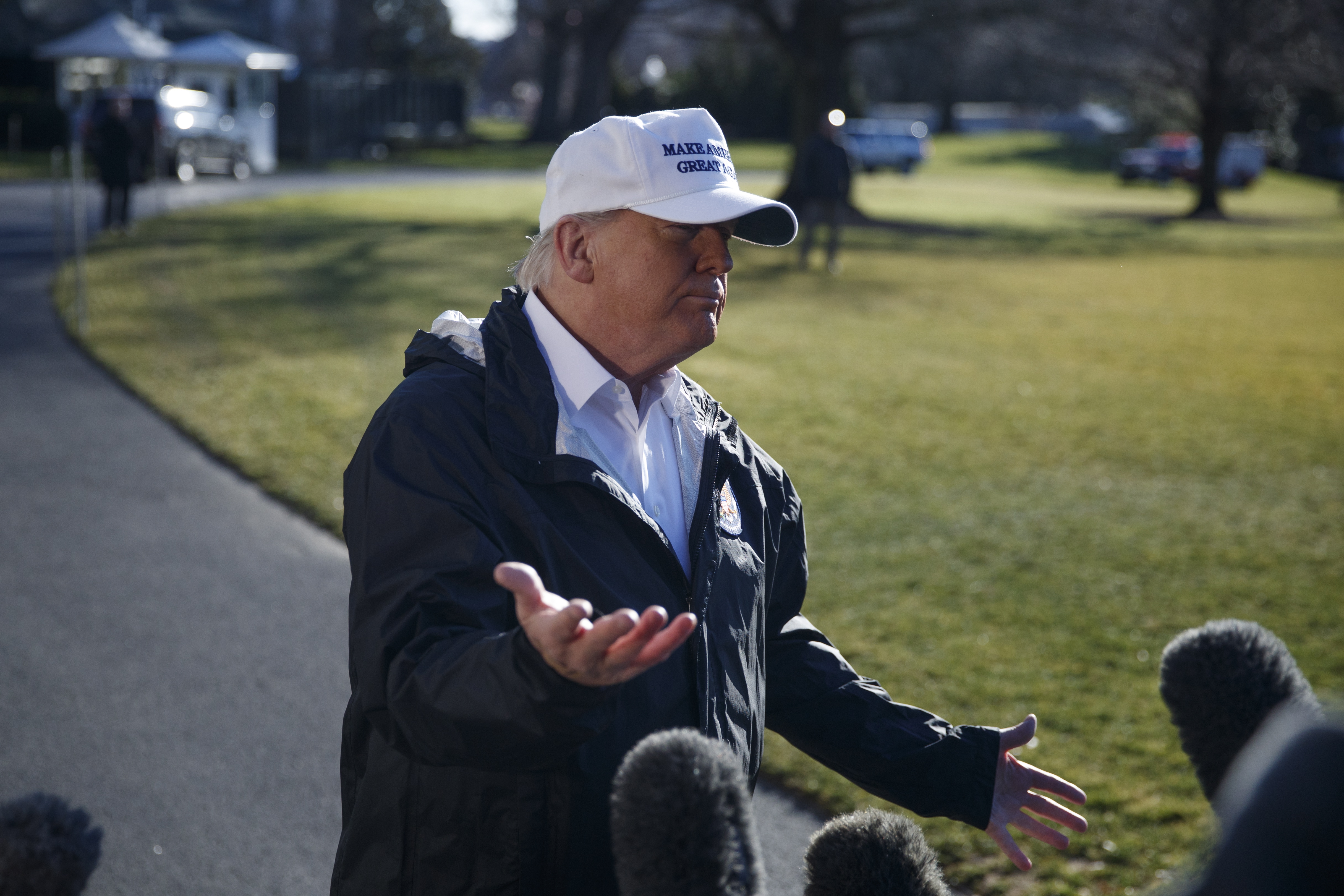 epa07273441 US President Donald J. Trump (C) responds to a question from the news media as he walks to board Marine One on the South Lawn of the White House in Washington, DC, USA, 10 January 2019. President Trump is traveling to Texas to participate in a roundtable on immigration and border security and to receive a briefing on border security.  EPA/SHAWN THEW