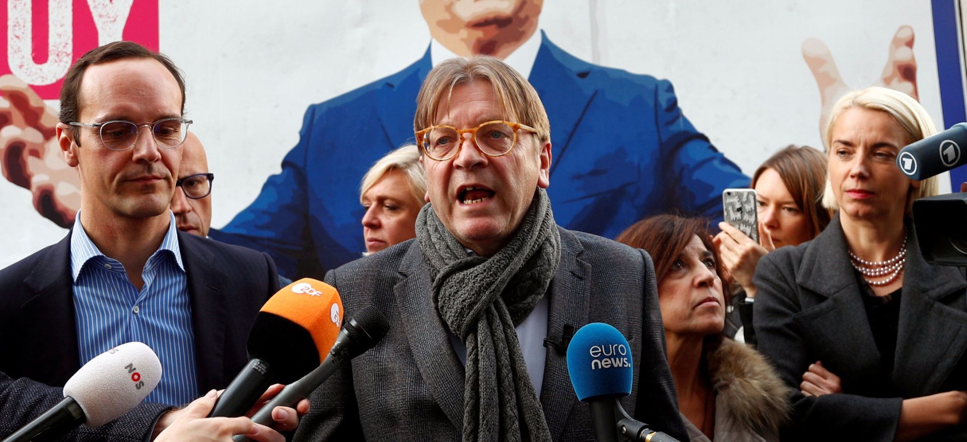 ALDE President Verhofstadt talks in front of an anti-Hungary's PM Orban billboard in Brussels Guy Verhofstadt, President of the Group of the Alliance of Liberals and Democrats for Europe (ALDE), and Marton Benedek of the Hungarian opposition party Momentum brief the media in front of a billboard truck showing a picture of Hungary's Prime Minister Viktor Orban outside the European Parliament in Brussels, Belgium November 6, 2018.   REUTERS/Francois Lenoir FRANCOIS LENOIR