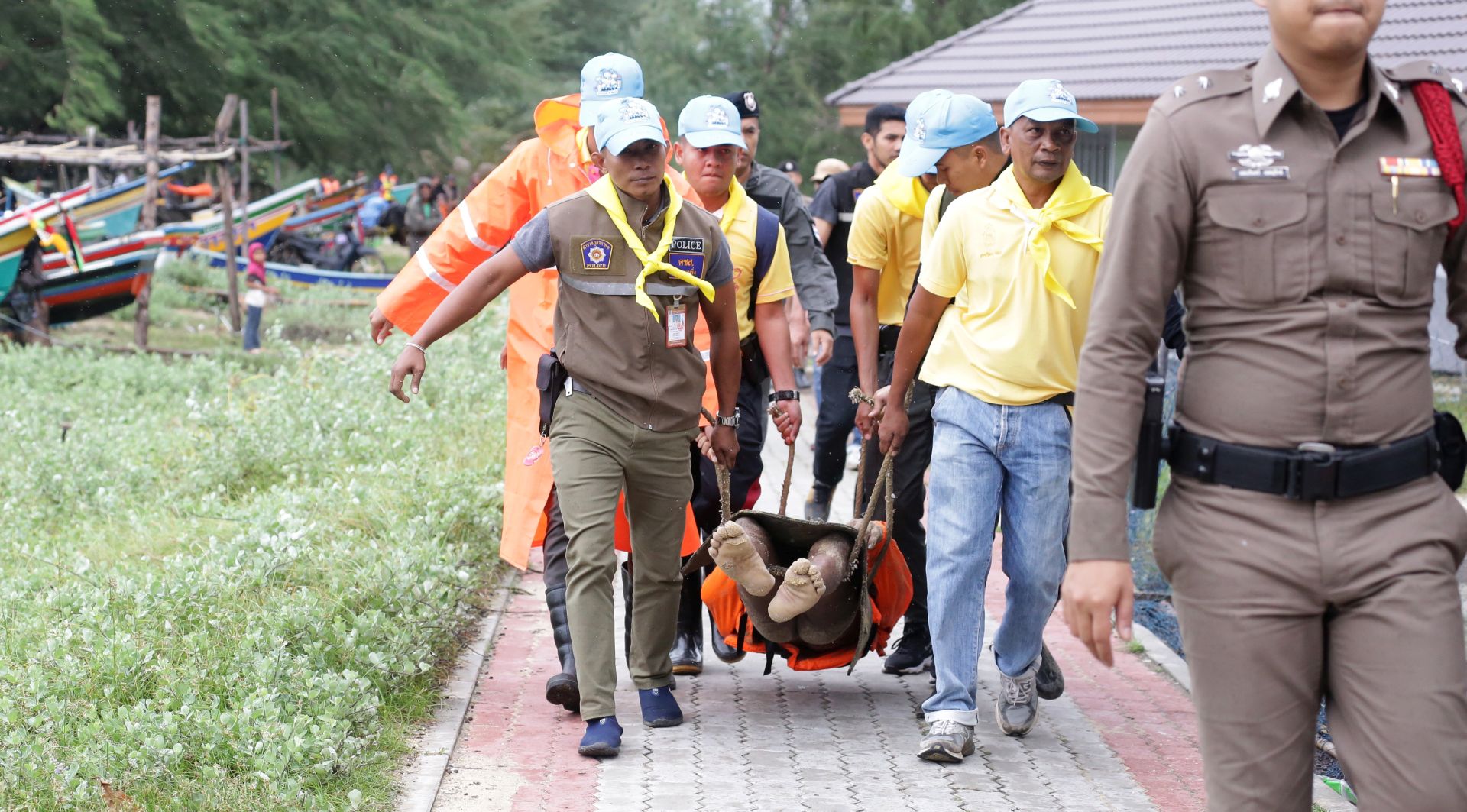 epa07261064 Thai rescue workers carry the body of a fisherman who drowned at sea following heavy downpours and high waves caused by tropical storm Pabuk in Pattani province, Thailand, 04 January 2019. Thousands of people evacuated from their homes after 11 southern coast provinces have been put on a weather warning as tropical storm Pabuk is expected to bring heavy downpours, strong winds and high waves. According to the Thai Meteorological Department, Tropical Storm Pabuk was moving west into the Gulf of Thailand on 03 January, with maximum winds of 65kph. Pabuk, poised to make landfall in southern Thailand on 04 January, will be the first tropical storm to hit the country outside of the monsoon season in nearly 30 years, media reported.  EPA/ABDULLAH WANGNI
