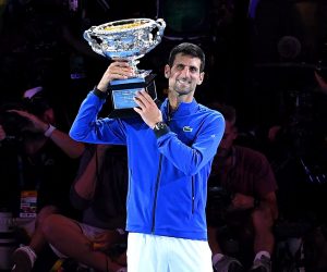 epa07324168 Novak Djokovic of Serbia raises the trophy after winning his men's singles final match against Rafael Nadal of Spain at the Australian Open Grand Slam tennis tournament in Melbourne, Australia, 27 January 2019.  EPA/ERIK ANDERSON EDITORIAL USE ONLY AUSTRALIA AND NEW ZEALAND OUT