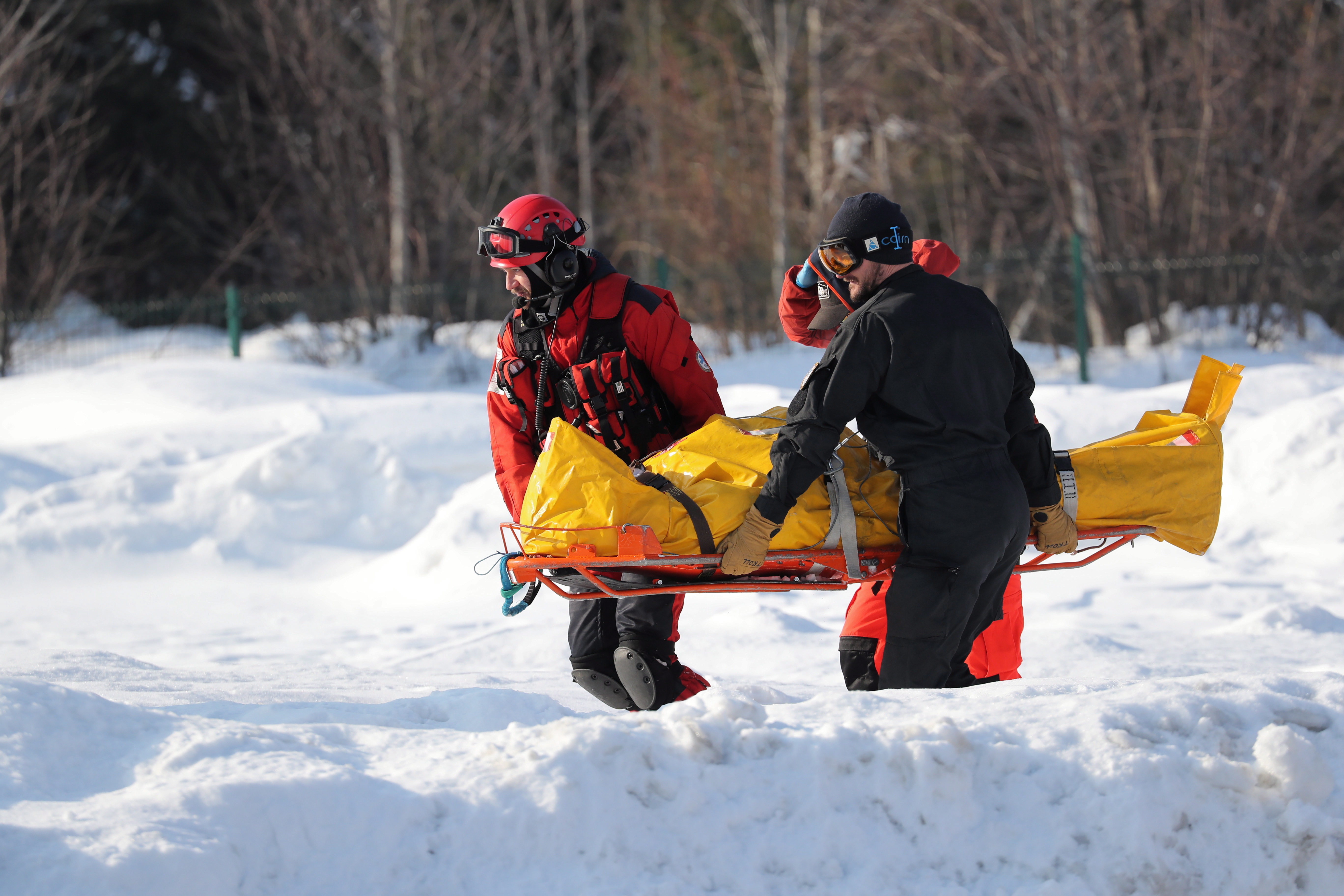 epa07331358 Medics transport an injured person to a helicopters of TOPR (Tatra Volunteer Rescue Service) which is flying to the hospital in Zakopane, Poland, 30 January 2019. Five people were injured after being hit by an avalanche, which descended from Rysy near Morskie Oko in the Tatra Mountains, on 30 January 2019. In the Tatras there is a moderate degree of avalanche danger.  EPA/Grzegorz Momot POLAND OUT