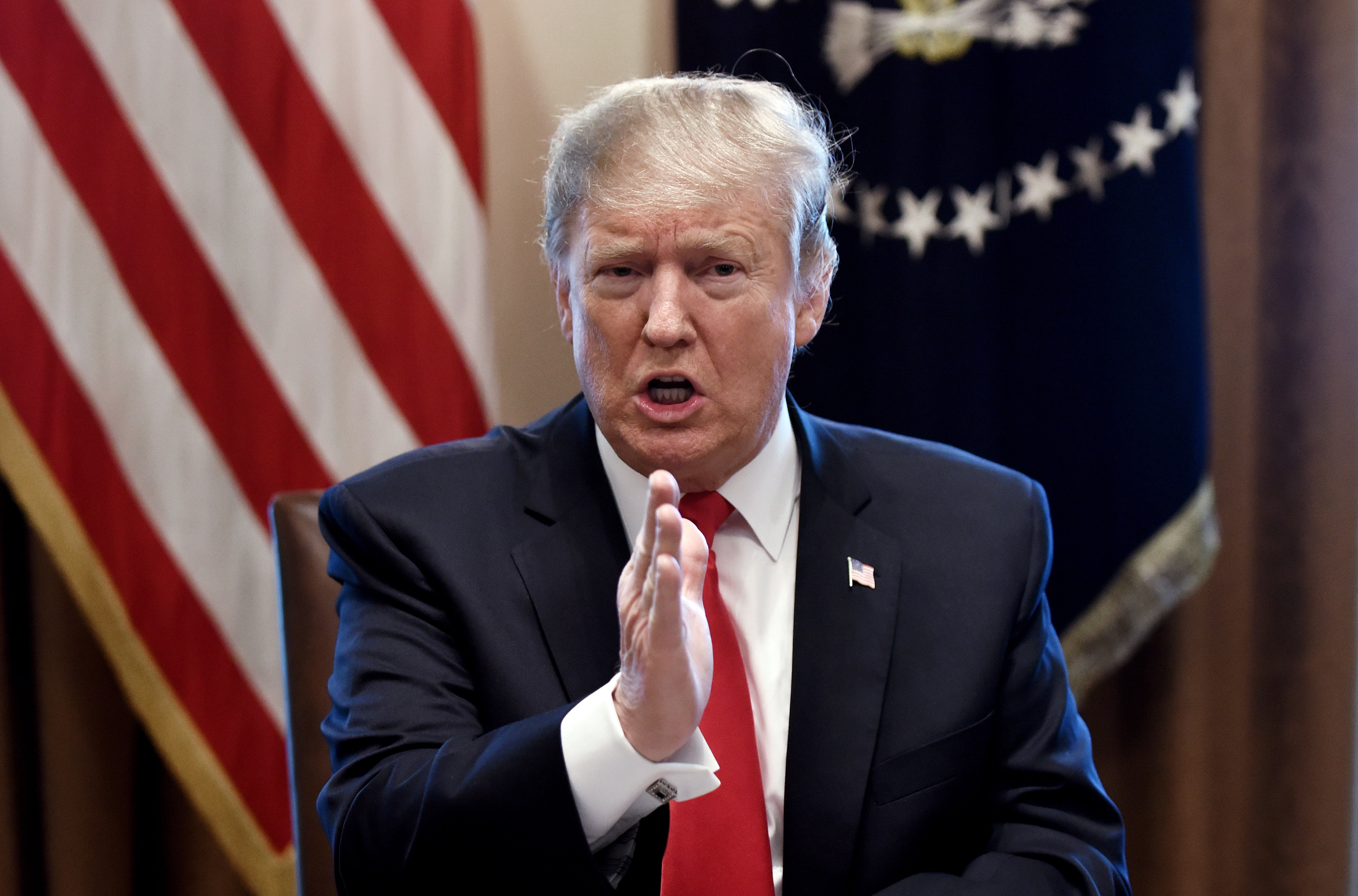 epa07336898 US President Donald J. Trump gestures during a meeting to discuss fighting human trafficking on the southern border in the Cabinet Room of the White House in Washington, DC, USA, 01 February 2019.  EPA/OLIVIER DOULIERY