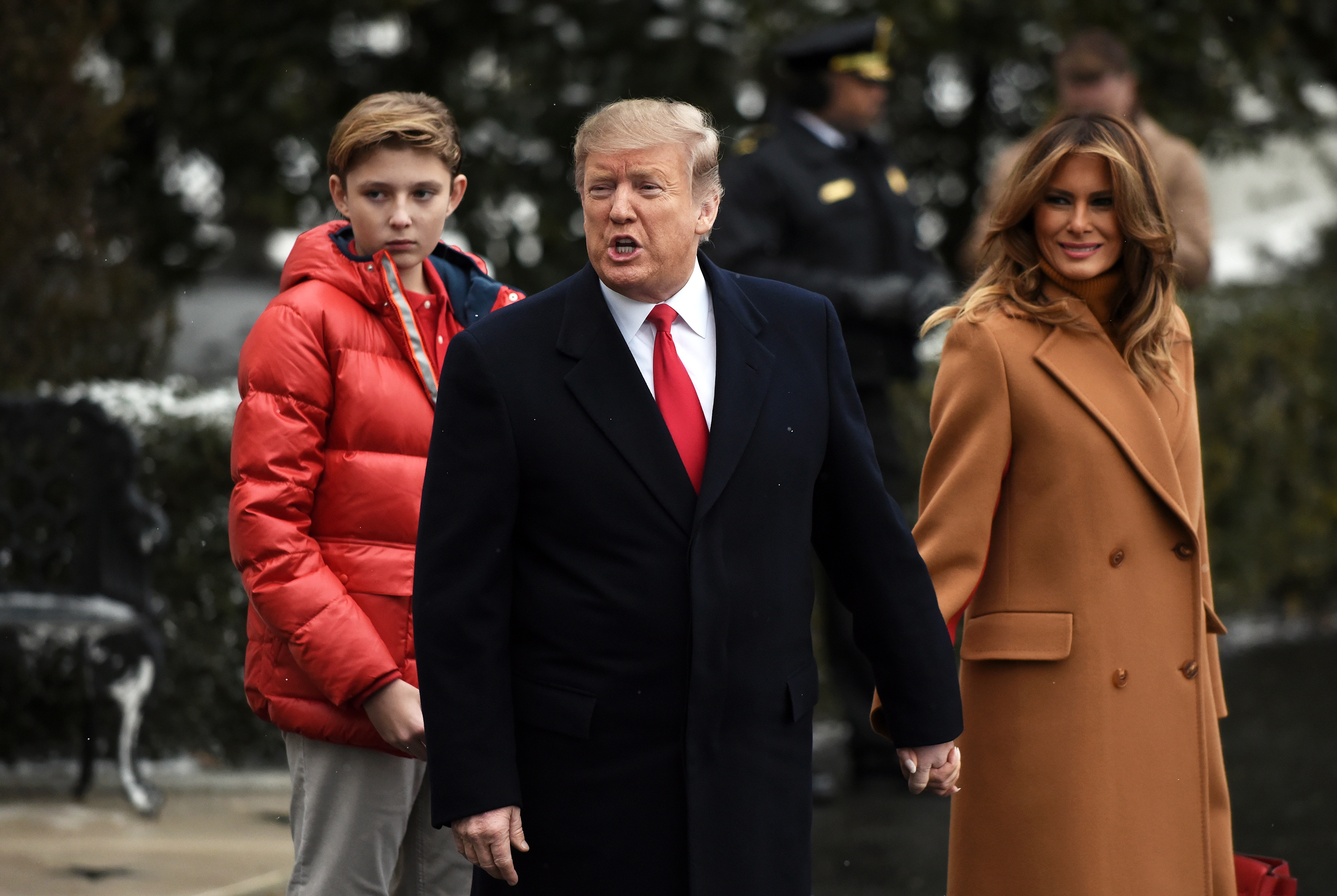 epa07337278 US President Donald J. Trump (C) with First Lady Melania Trump (R) and their son Barron Trump (L) departs the White House en route to Florida on Marine One in Washington, DC, USA, 01 February 2019.  EPA/OLIVIER DOULIERY