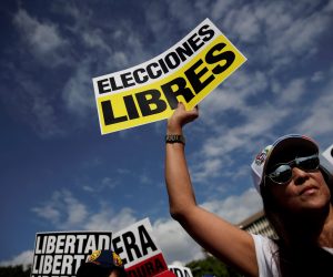 epa07339763 A woman holds a sign that reads 'Free election' during a rally to show support to President of the Venezuelan National Assembly Juan Guaido and protest against the crisis in their country, in Panama City, Panama, 02 February 2019. Venezuela's President Maduro and his opponent National Assembly leader Juan Guaido have called on their supporters to take to the streets as international pressure increased on Maduro to resign. Guiado had declared himself interim president of Venezuela on 23 January and promised to guide the country toward new election as he consider last May's election not valid.  EPA/Bienvenido Velasco