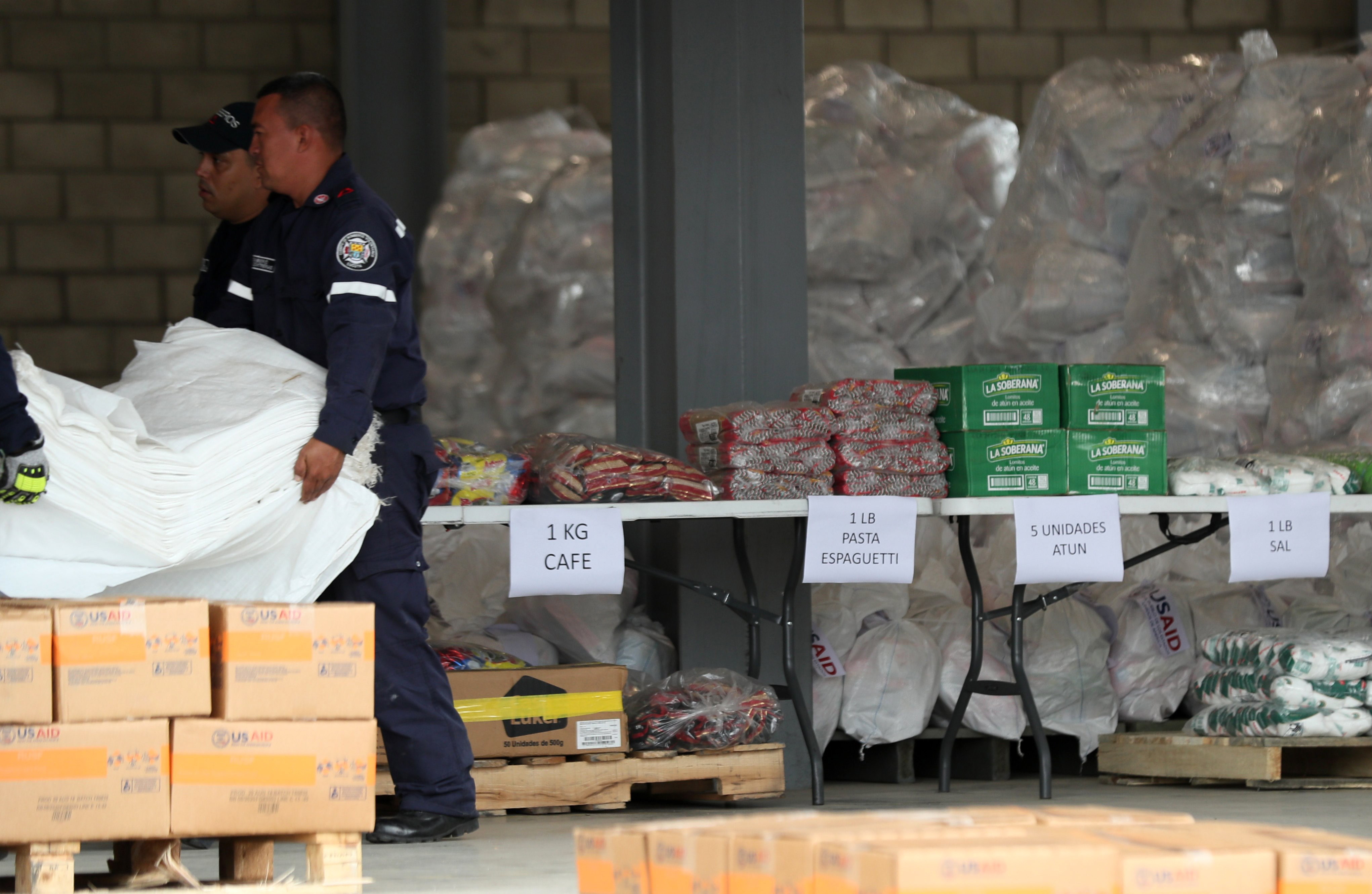 epa07352999 Authorities organize the shipment with humanitarian aid for Venezuela in a collection center located at the international bridge of Tienditas, in Cucuta, Colombia, 08 February 2019. The first trucks with humanitarian aid arrived the previous day to Cucuta, where officials work on logistics for its delivery.  EPA/MAURICIO DUENAS CASTADENAS