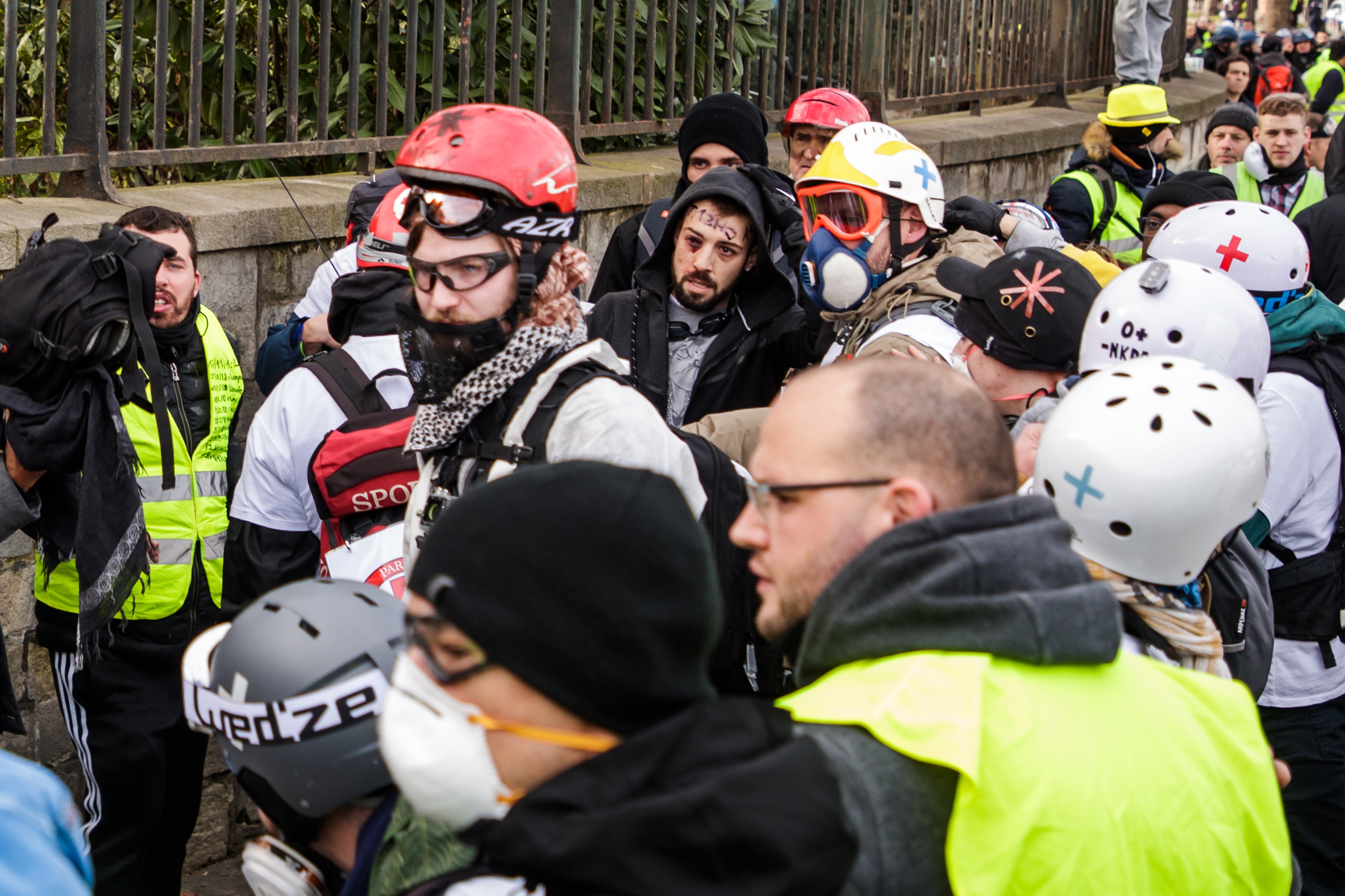 epa07356825 Street medics evacuate a protester (C-R) from the 'Gilets Jaunes' (Yellow Vests) movement after he was severely injured in the hand as clashes erupt during the 'Act XIII' demonstration, the 13th consecutive national protest on a Saturday, in Paris, France, 09 February 2019. The so-called 'Gilets Jaunes' is a grassroots protest movement with supporters from a wide span of the political spectrum, that originally started with protest across the nation in late 2018 against high fuel prices. The movement in the meantime also protests the French government's tax reforms, the increasing costs of living and some even call for the resignation of French President Emmanuel Macron.  EPA/CHRISTOPHE PETIT TESSON