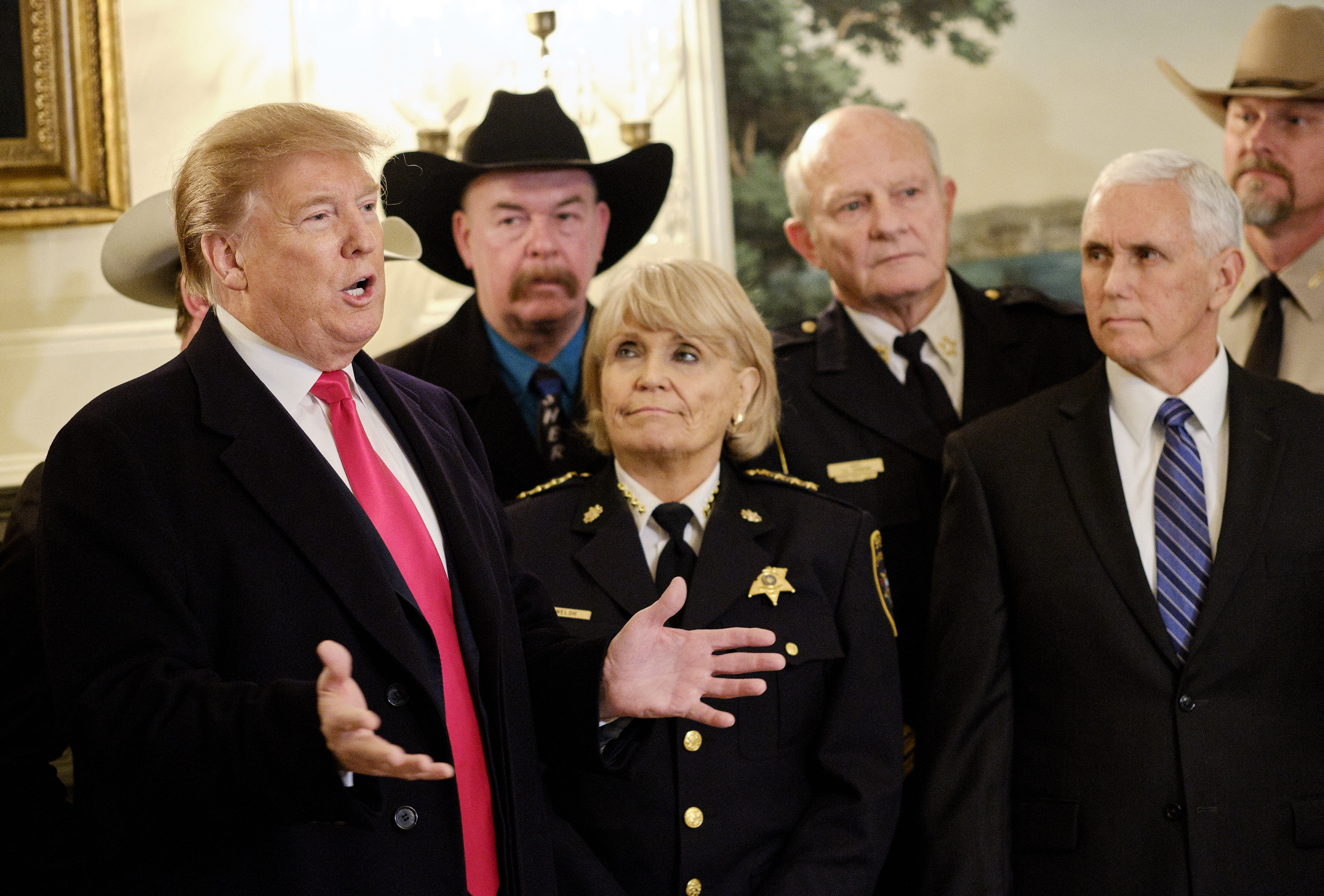 epa07363174 US President Donald J. Trump (L), with US Vice President Mike Pence (R), speaks to the press after meeting with sheriffs from across the country before departing for a rally in Texas, in the Diplomatic Reception Room at the White House in Washington, DC, USA, on 11 February 2019.  EPA/T.J. Kirkpatrick / Bloomberg POOL