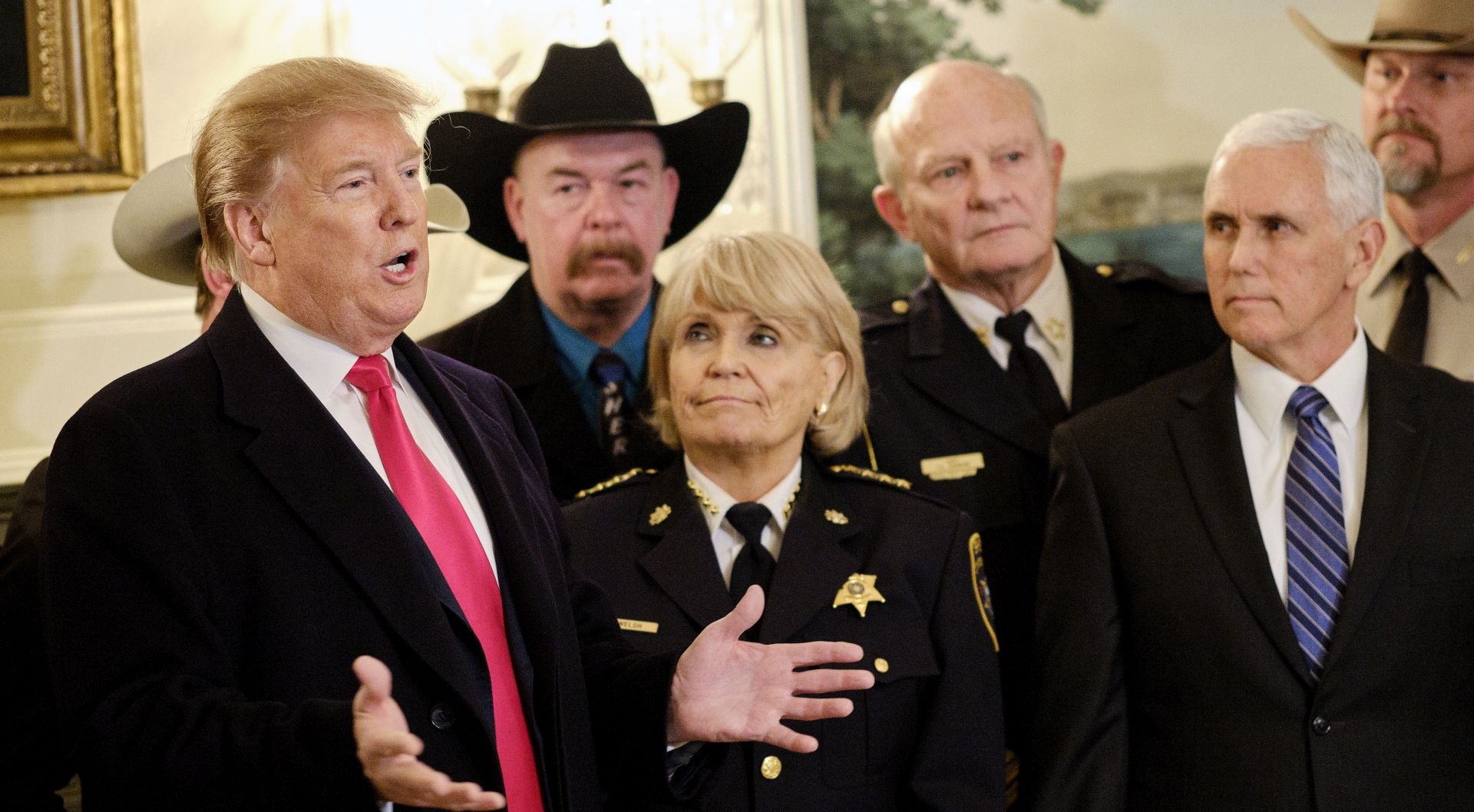 epa07363174 US President Donald J. Trump (L), with US Vice President Mike Pence (R), speaks to the press after meeting with sheriffs from across the country before departing for a rally in Texas, in the Diplomatic Reception Room at the White House in Washington, DC, USA, on 11 February 2019.  EPA/T.J. Kirkpatrick / Bloomberg POOL