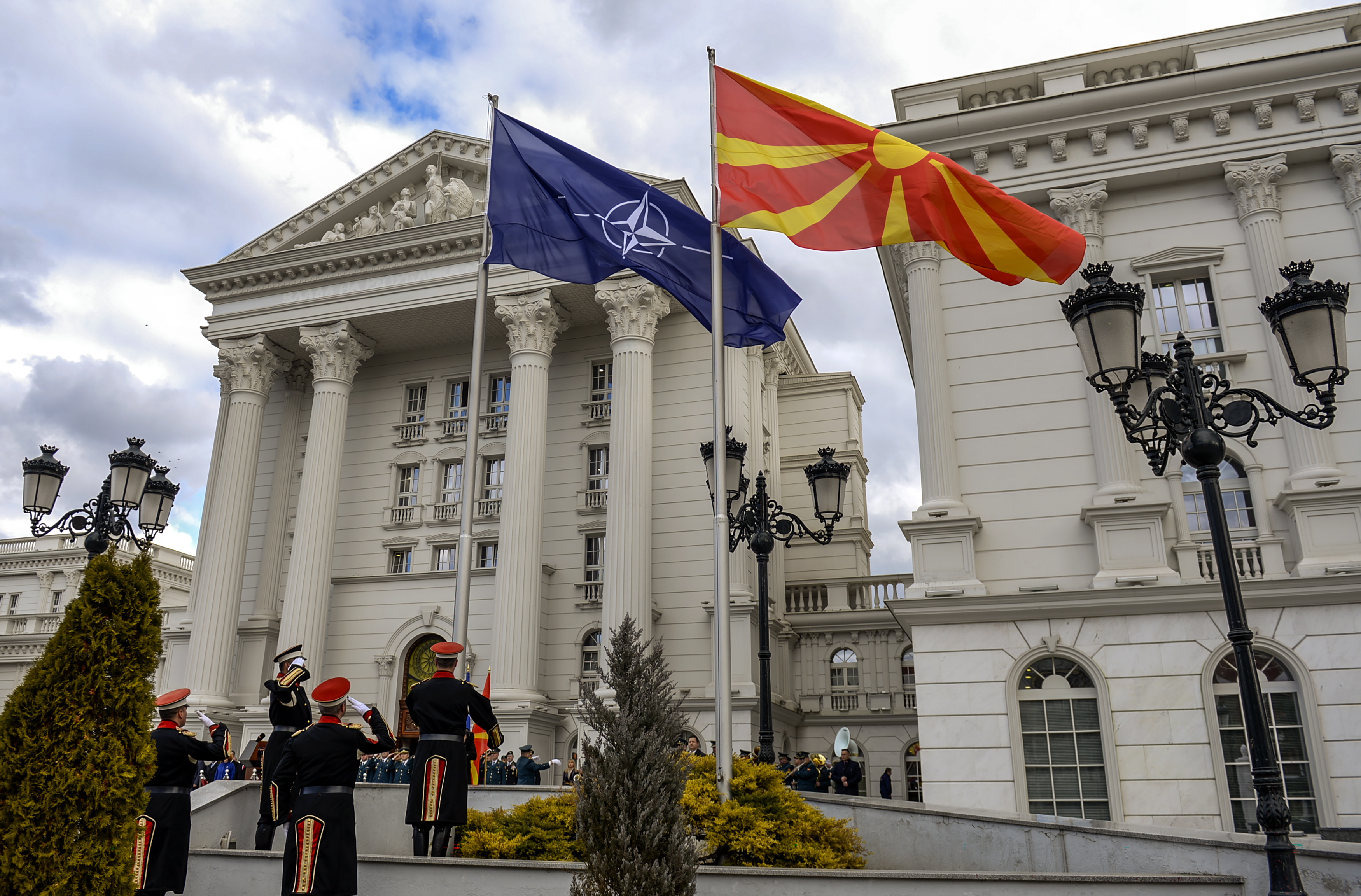 epa07364096 Members of a honor guard hoist the NATO flag alongside the Macedonian flag in front of the government building in Skopje, The Former Yugoslav Republic of Macedonia (FYROM), 12 February 2019. The former Yugoslav Republic of Macedonia's government is due to change the name of the country after the ratification of the 'Protocol of the North Atlantic Treaty for the Accession of North Macedonia' whereby Greece will approve the accession of its northern neighbor to NATO under its new name, as provided by the Prespes Agreement signed by Athens and Skopje.  EPA/GEORGI LICOVSKI