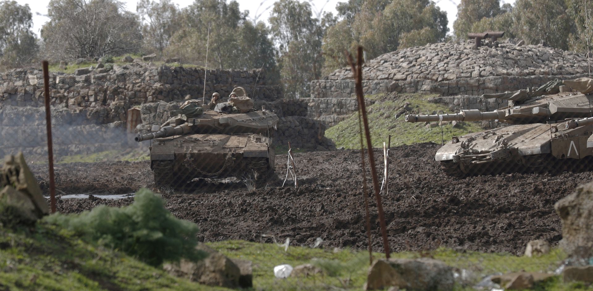 epa07364344 Israeli tanks patrol during training in the Golan Heights near the city of Quneitra on the Israeli-Syrian Border, 12 February 2019. According to media reports, Israeli army targeted Syrian lookout post overnight. The attack reportedly targeted a previously destroyed hospital and the tal-aderiya area near the city of Quneitra with tanks and artillery shells. Reports said two Iranian soldiers were killed from the attacks on Quneitra which Syria attributed to Israel.  EPA/ATEF SAFADI