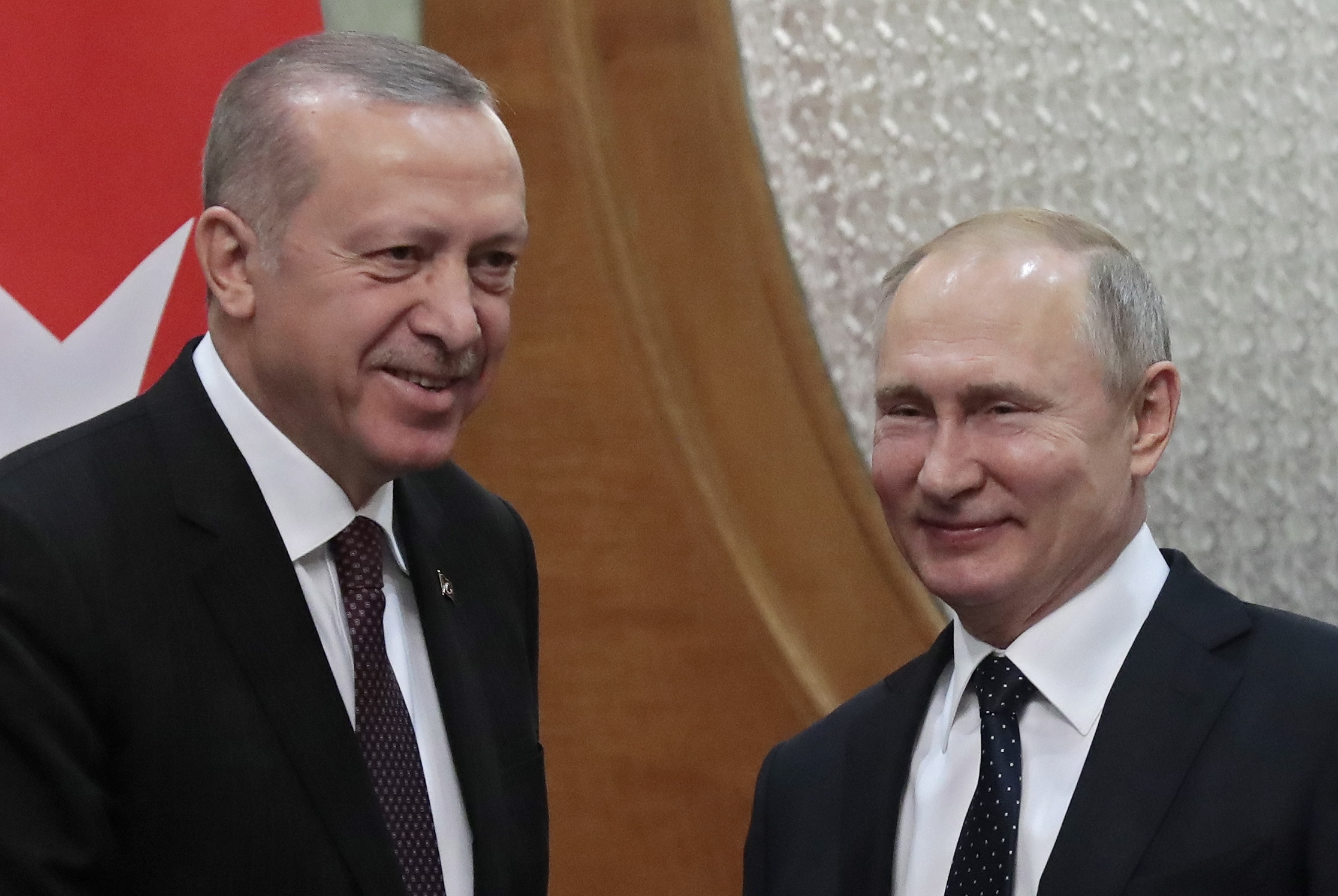 epa07368950 Turkish President Recep Tayyip Erdogan (L) and Russian President Vladimir Putin (R) smile during their meeting in the Black sea resort of Sochi, Russia, 14 February 2019. The leaders of Russia, Turkey and Iran held in Sochi on 14 February their fourth trilateral meeting to discuss further joint steps with a view to a long-term peace settlement in Syria.  EPA/SERGEI CHIRIKOV