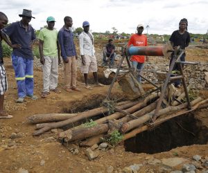 epa07369916 People gather around one of the shafts at Cricket Mine outside Kadoma more than 200 km west of the capital Harare, Zimbabwe, 14 February 2019 where more than 40 artisanal miners died on 12 February 2019.The miners died when the shafts in which they working in were flooded by raining water.Efforts are being made to pump out the water so that the bodies can be retrieved.  EPA/AARON UFUMELI