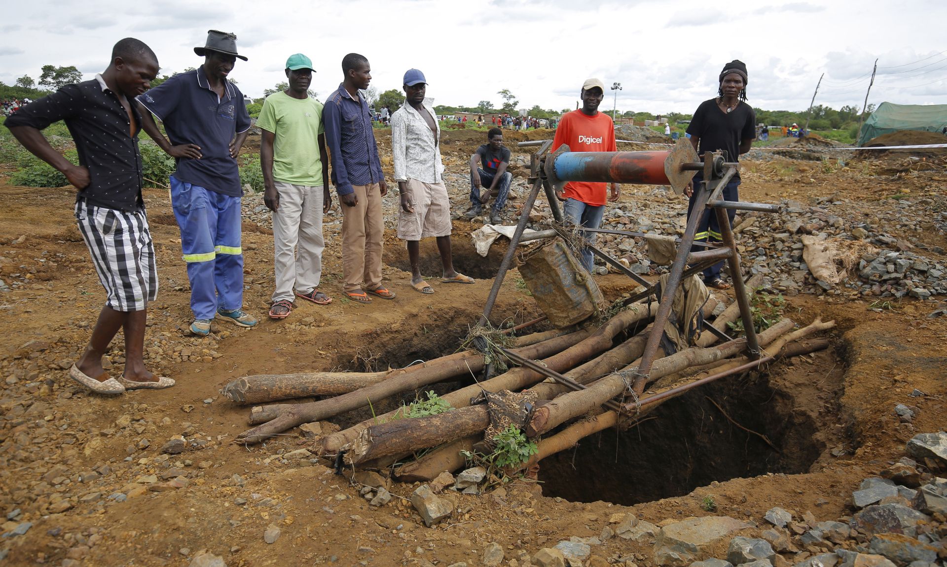 epa07369916 People gather around one of the shafts at Cricket Mine outside Kadoma more than 200 km west of the capital Harare, Zimbabwe, 14 February 2019 where more than 40 artisanal miners died on 12 February 2019.The miners died when the shafts in which they working in were flooded by raining water.Efforts are being made to pump out the water so that the bodies can be retrieved.  EPA/AARON UFUMELI