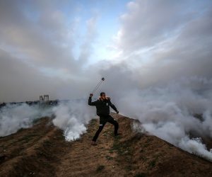 epa07372985 A Palestinian protester throw stones by his slingshot during clashes after Friday protests near the border between Israel and Gaza Strip, east Gaza, 15 February 2019. According to reports, 20 Palestinian protesters were wounded during the clashes along the border between Gaza Strip and Israel. Palestinian protesters call for the right of Palestinian refugees across the Middle East to return to homes they fled in the war surrounding the 1948 creation of Israel.  EPA/MOHAMMED SABER