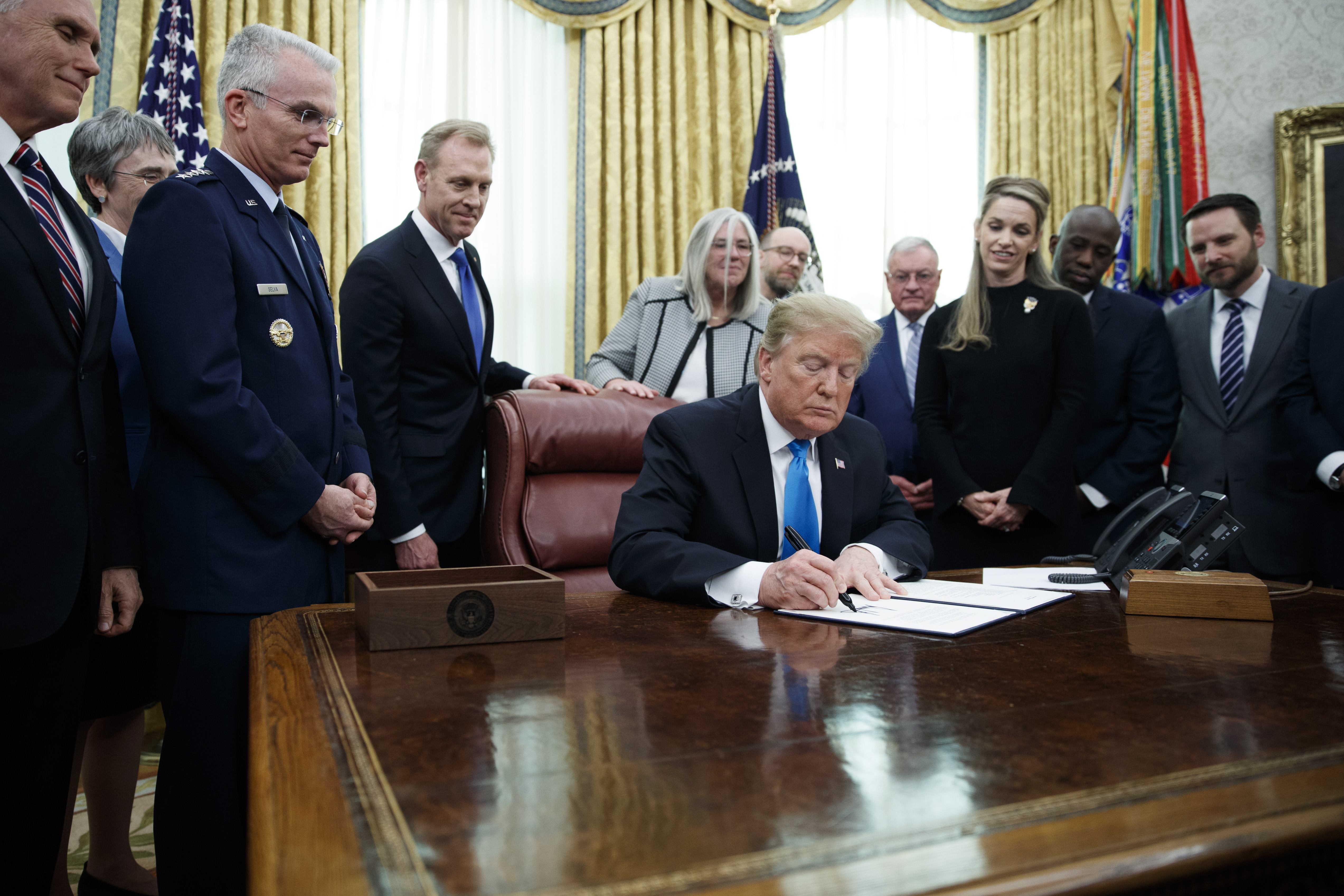 epa07381620 US President Donald J. Trump (C) participates in a signing ceremony for Space Policy Directive 4 in the Oval Office of the White House in Washington, DC, USA, 19 February 2019. The policy directive establishes the Space Force as the 6th branch of US armed forces operating within the department of the Air Force.  EPA/SHAWN THEW