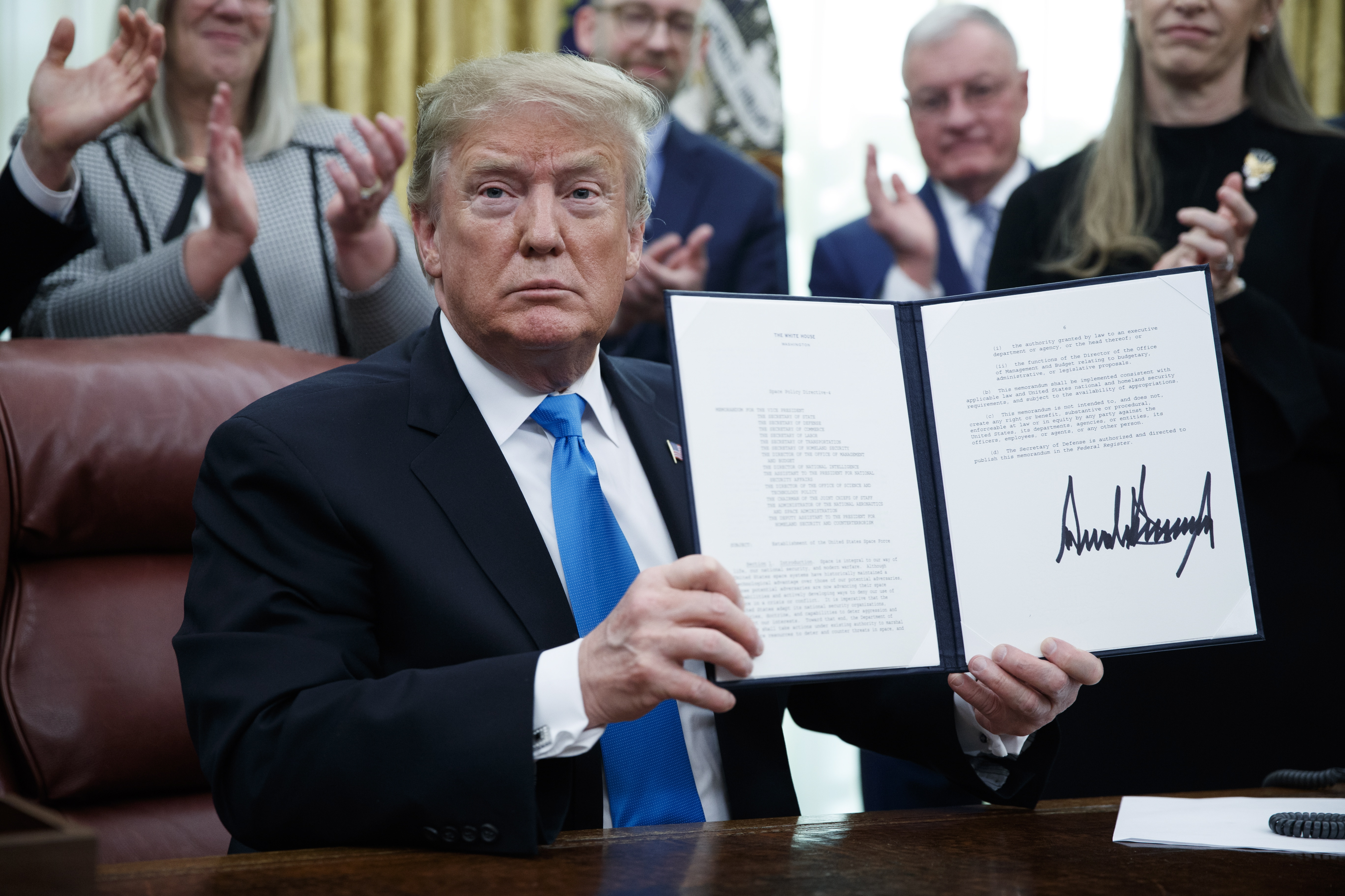 epa07381615 US President Donald J. Trump participates in a signing ceremony for Space Policy Directive 4 in the Oval Office of the White House in Washington, DC, USA, 19 February 2019. The policy directive establishes the Space Force as the 6th branch of US armed forces operating within the department of the Air Force.  EPA/SHAWN THEW