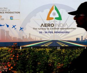 epa07378721 Silhouetted Indian Airforce personnel walks near a banner ahead of the 'Aero India-2019' at the Yelahanka air base in Bangalore, India, 18 February 2019. Over 350 defense and aerospace firms, including foreign companies from 30 countries have confirmed their participation to take part in the 12th biennial Aero Show event which will be held at the Yelahanka air force base and showcases Its military capabilities and aims to induct new warplanes, next-generation submarines, warships, helicopters, missiles, howitzers, air defense systems, assault weapons and night-vision gear. The event runs from 20 to 24 February 2019.  EPA/JAGADEESH NV