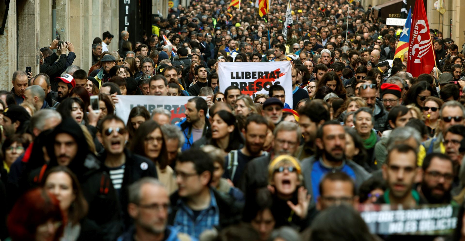 epa07385133 Several thousand demonstrators hold banners reading 'Democracy' during a rally amid the 24-hour Catalan general strike, called by Intersindical-CSIC trade union, in downtown Barcelona, northeastern Spain, 21 February 2019. This protest was called in Catalonia against the case trial of pro-independence defendants at Spain's Supreme Court. This strike is the third one, directly linked to pro-independence process, that was called in the Spanish region. The first Catalan 'national' strike was called on 03 October 2017, two days after October 1st referendum, and the second one was organized on 08 November 2017.  EPA/Toni Albir