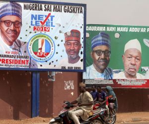 epa07388221 Nigerians ride past campaign billboards in Daura, Katsina, Nigeria, 22 February 2019. Nigerians head to the polls 23 February 2019 after a weeks delay announced by the Independent National Electoral Commission (INEC).  EPA/GEORGE ESIRI