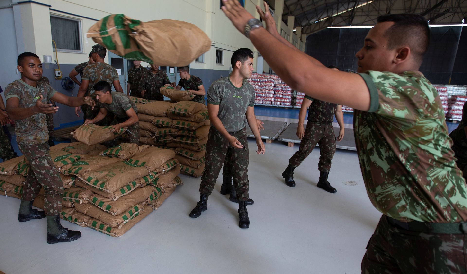 epa07388257 Brazilian soldiers organize a shipment with humanitarian aid destined for Venezuela in Boa Vista, Brazil, 22 February 2019. The first plane with the humanitarian aid that Brazil will send to Venezuela arrived on the same day to the bordering state of Roraima, from which it will try to to move it to the neighboring country a day later, in spite of the closing of the border ordered by the Government of Nicolas Maduro. The Brazilian Air Force plane landed at the military base in Boa Vista with a load of 22 tons of milk powder and about 500 first aid kits, which include medicines and other medical materials donated by the Government of Jair Bolsonaro.  EPA/JOEDSON ALVES