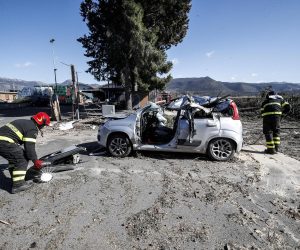 epa07390141 Firefighters at work at the scene of the incident in Guidonia, near Rome, Italy, 23 February 2019. A tree fell on a car due to the strong wind. and the man driving the car, a 45-year-old from Romania, has died. Several trees have fallen in the area because of the strong wind.  EPA/GIUSEPPE LAMI