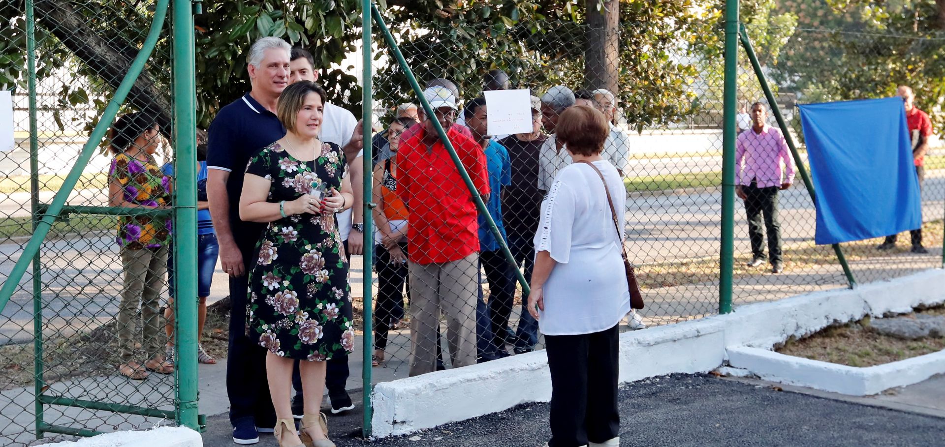 epa07393028 Cuban President Miguel Diaz-Canel (L), accompanied by his wife Liz Cuesta Peraza (C), lines up at the entrance of an electoral college to vote in the referendum on the new Constitution, in Havana, Cuba, 24 February 2019. More than 25,000 polling stations opened their doors this Sunday in Cuba to vote in the referendum on the new Constitution - which ratifies communism and as a novelty recognizes private property - and to which more than eight million citizens are summoned.  EPA/ERNESTO MASTRASCUSA