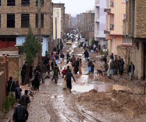epa07367292 Afghan people affected by seasonal floods remove mud and flood water from the streets as they wait for relief, near their houses in Herat, Afghanistan, 13 February 2019. According to local reports, at least five people were killed and several houses were damaged in flash floods affecting parts of the Herat.  EPA/JALIL REZAYEE